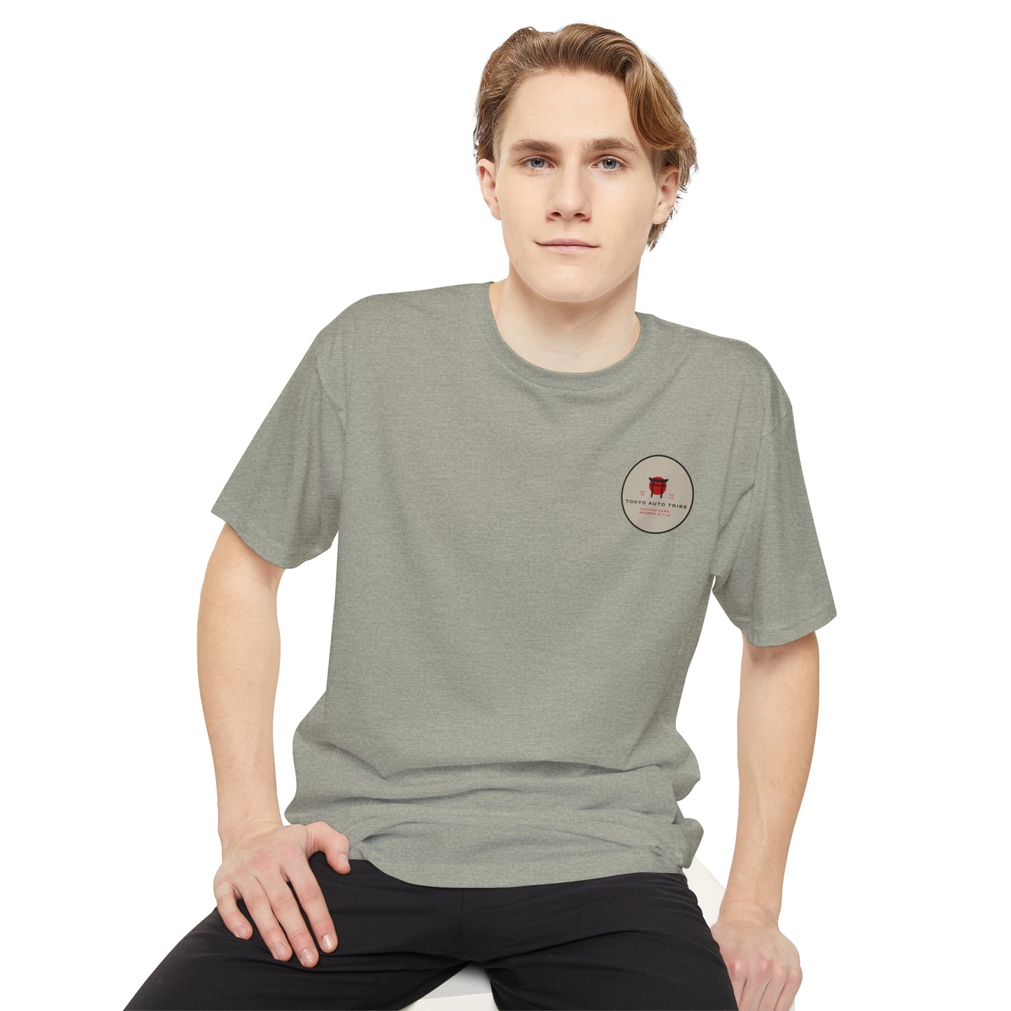 Young man wearing a gray Unbreakable Spirit oversized T-Shirt featuring a small red graphic on the chest, embodying Japanese car culture and vintage drift style.