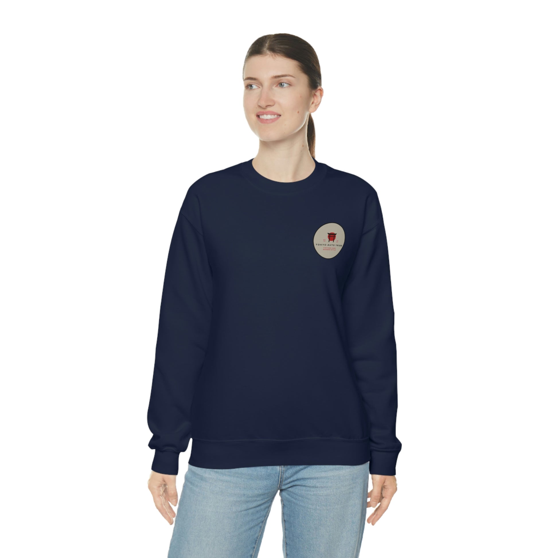 A woman wearing The Family Wagon Sweater in navy blue, featuring a small circular graphic emblem on the chest, embodying Japanese car culture and tuner-inspired streetwear style.