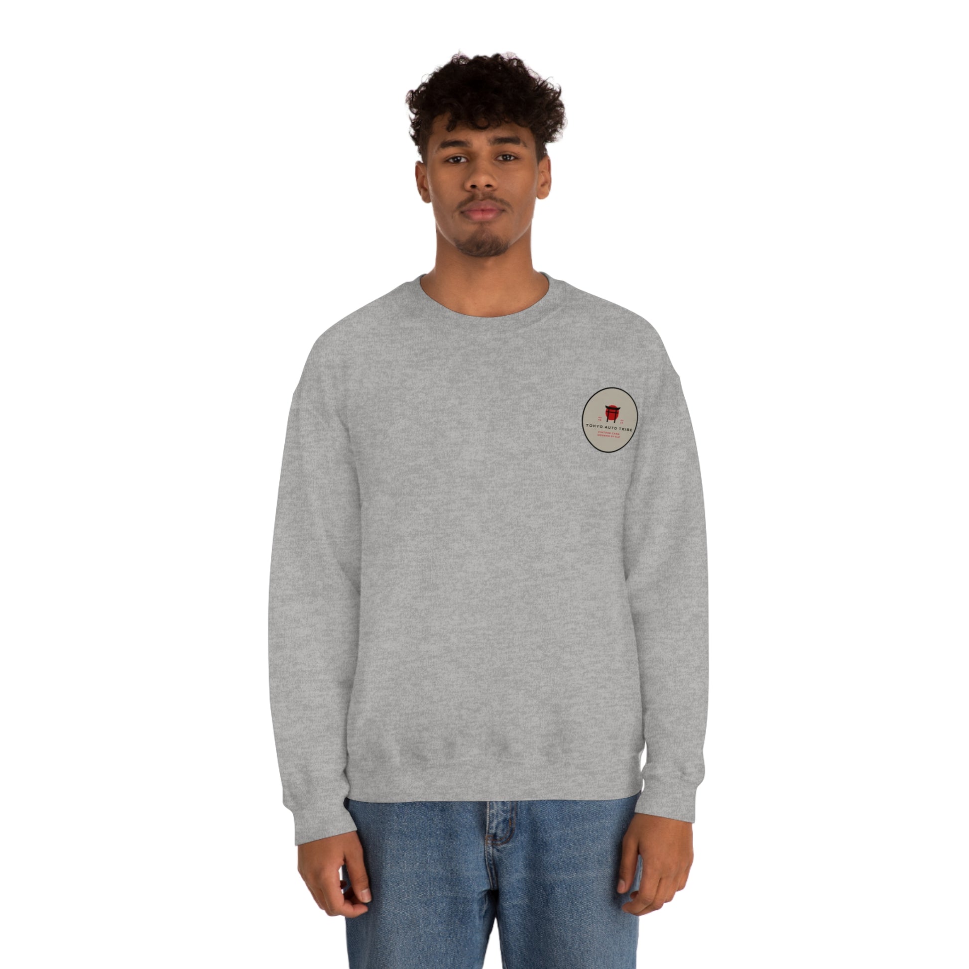 Man wearing a gray Wagon Chibi Sweater featuring a small graphic on the chest, styled for fans of Japanese car culture and late-night drives.