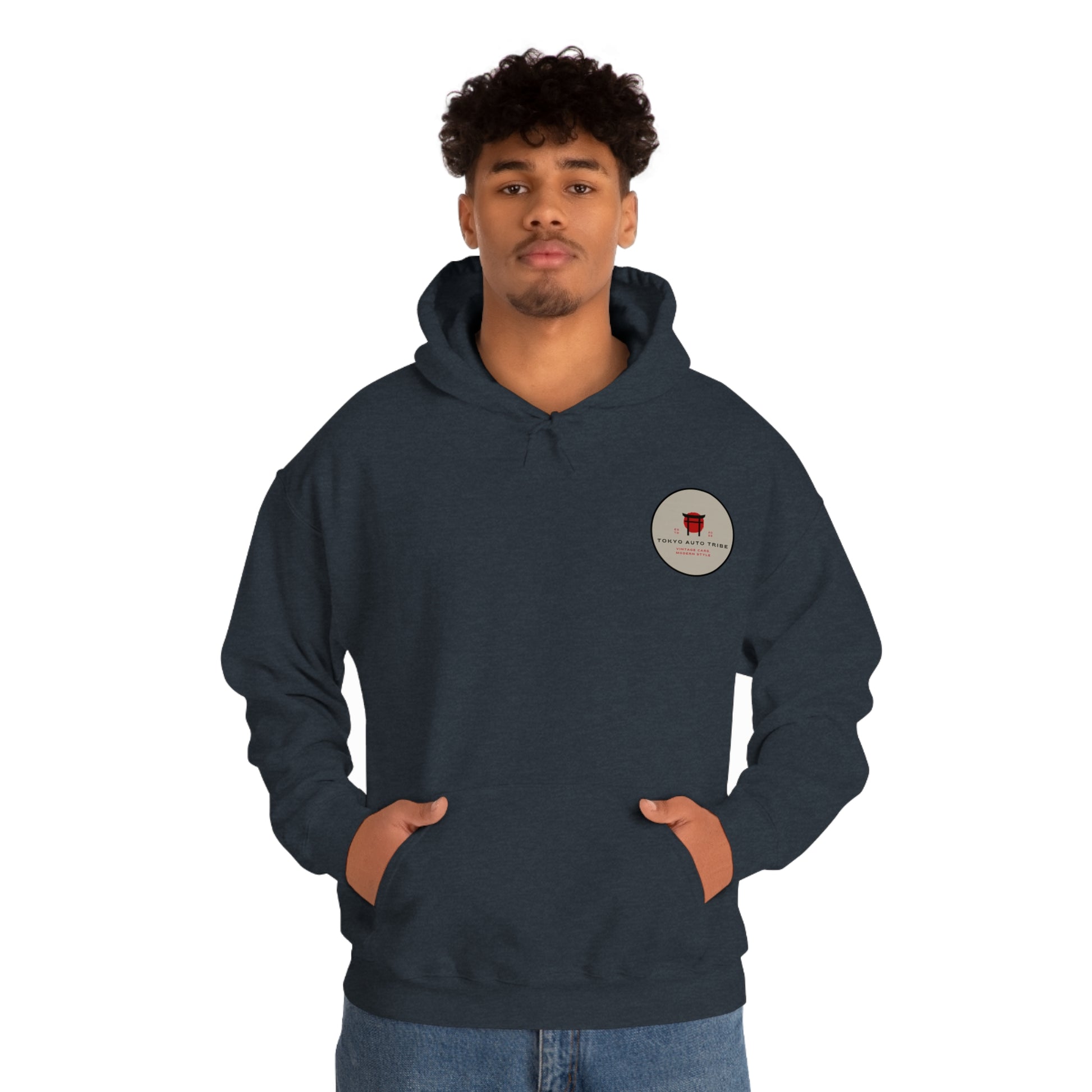 Man wearing a dark blue Wagon Chibi Hoodie featuring a small circular logo on the chest, designed for fans of Japanese car culture, late-night drives, and tuner lifestyle.