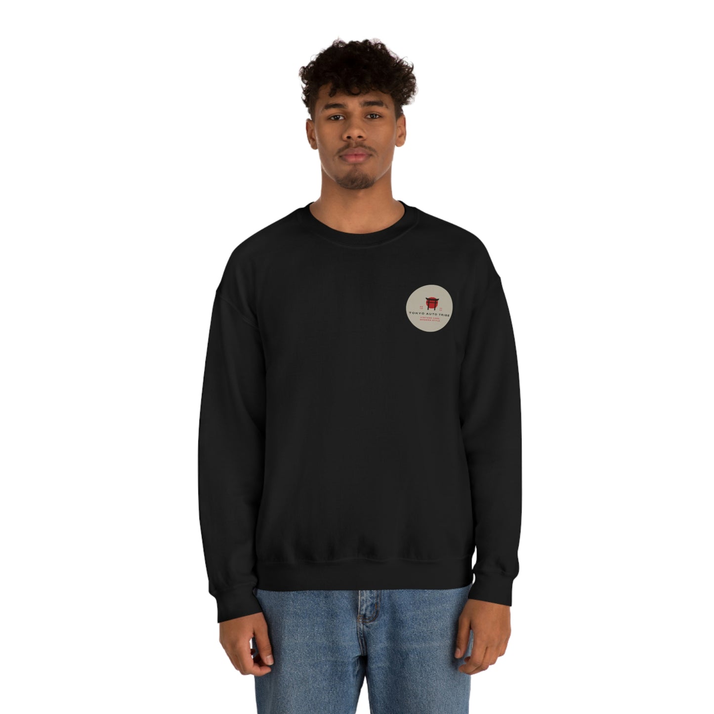 Front view of a man wearing The Family Wagon Sweater in black, featuring a small circular graphic on the chest inspired by Japanese car culture, representing tuner and drift lifestyle.