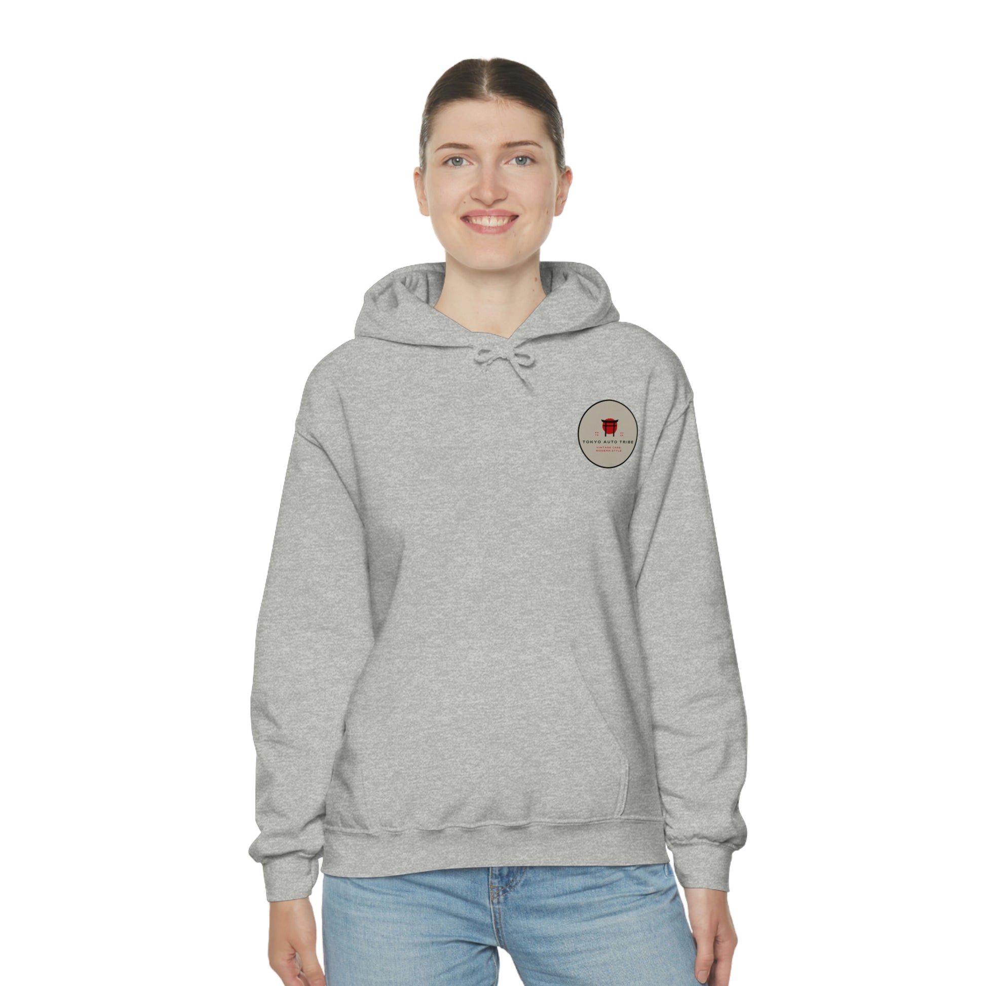 Woman wearing a light gray Groovy Grocery Runner Hoodie with a small graphic on the chest, styled for enthusiasts of Japanese car culture and streetwear fashion.
