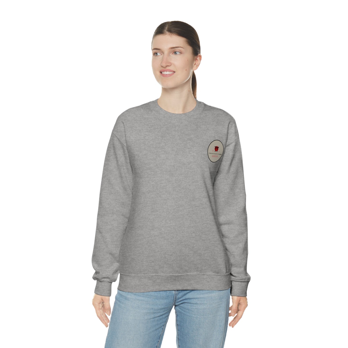 Woman wearing a gray Wagon Chibi Sweater with subtle automotive-inspired graphic on the chest, paired with light blue jeans, embodying casual Japanese car culture style.