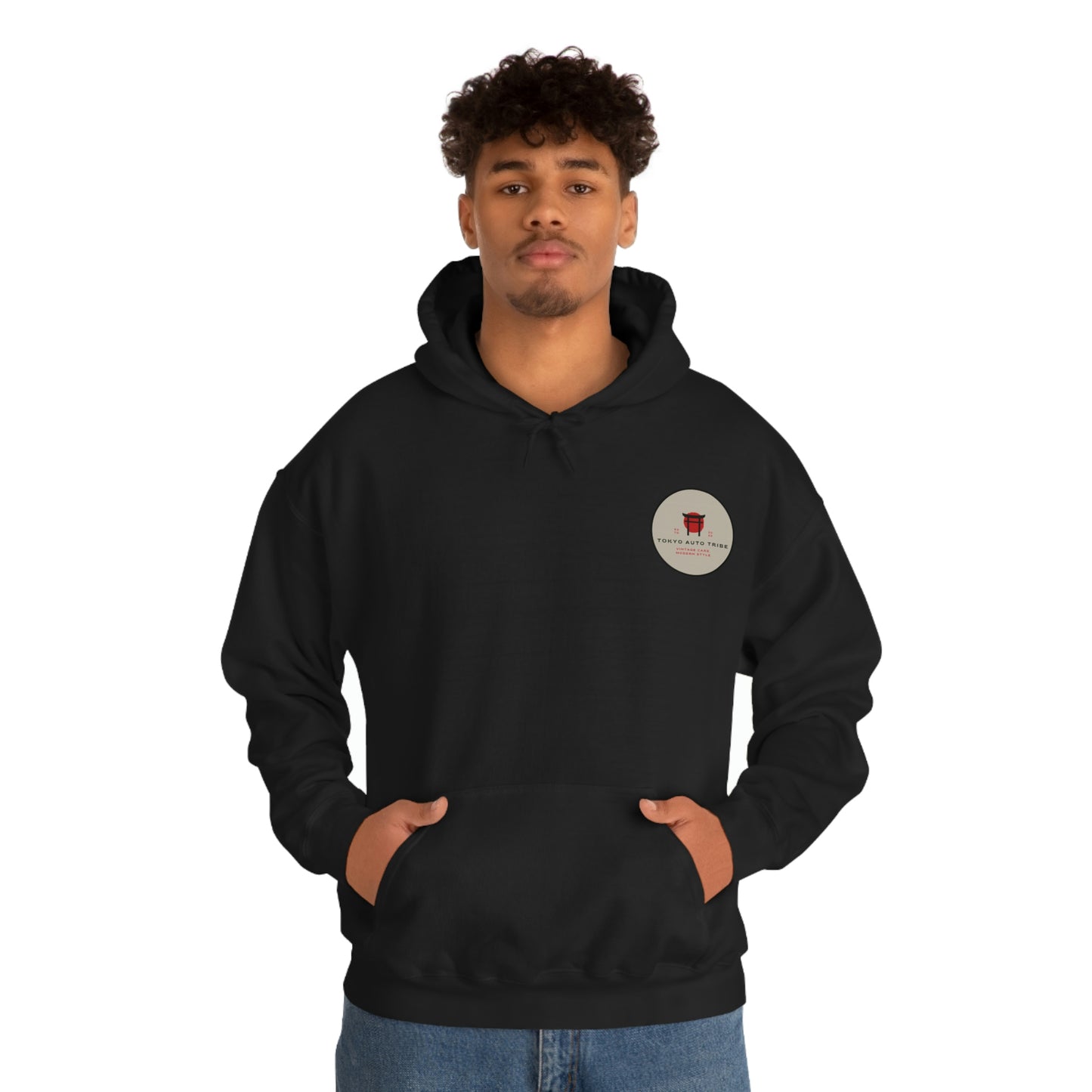 A young man wearing a black Godzilla's Fury Hoodie with a small circular graphic on the chest, posing with hands in the front pocket against a plain white background.