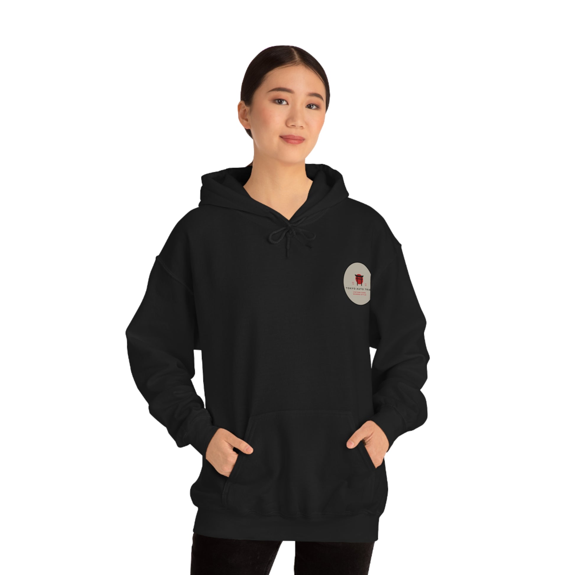 Young woman wearing a black Wagon Chibi Hoodie with a small graphic on the chest, styled for fans of Japanese car culture, late-night drives, and tuner streetwear.