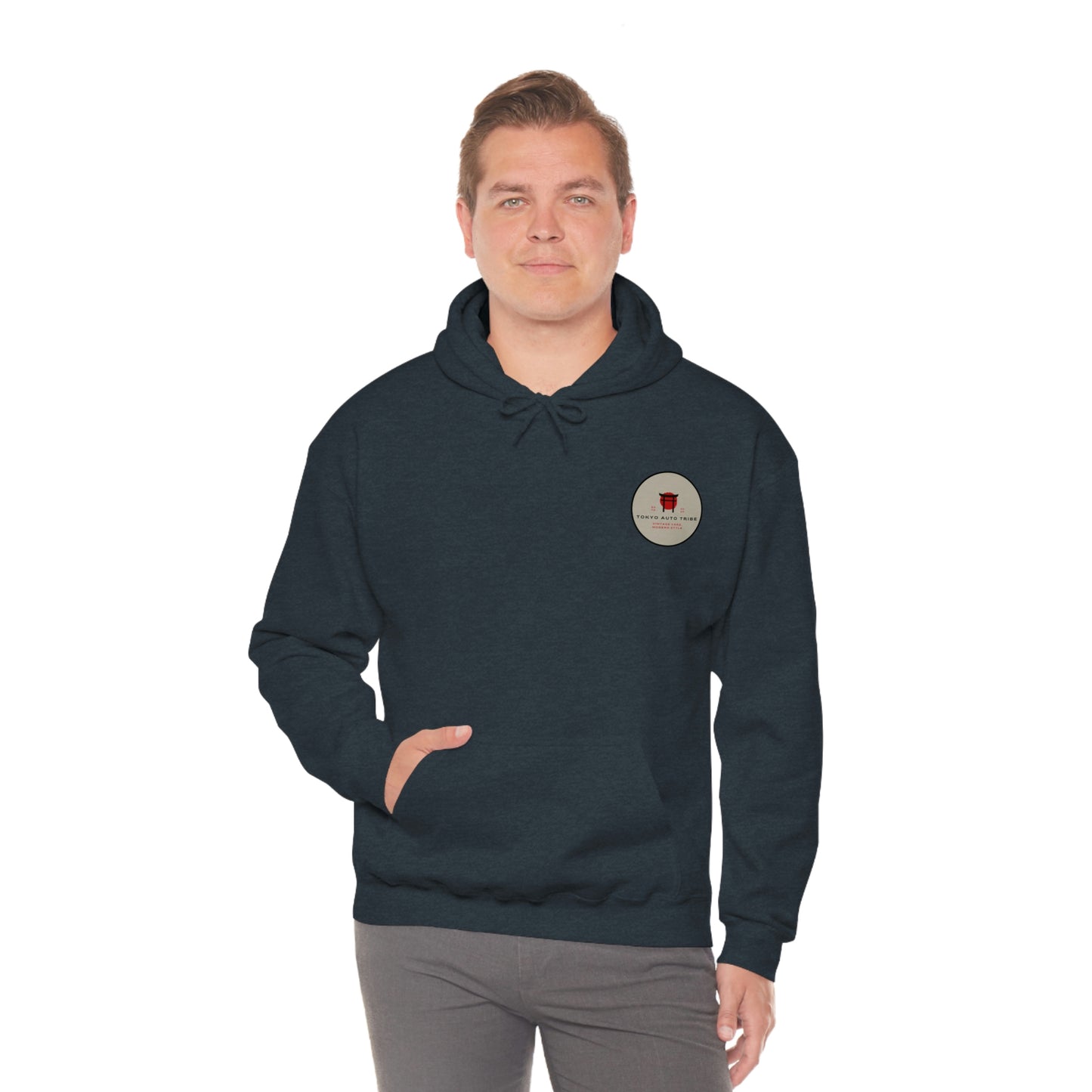 Man wearing a dark hoodie with a small circular graphic on the chest, posing with one hand in the pocket of the Godzilla's Fury Hoodie, styled for casual streetwear.