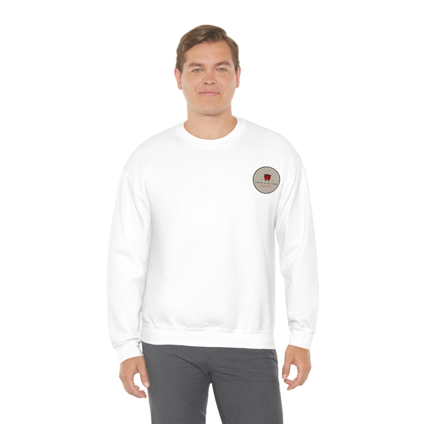 Man wearing a white Wagon Chibi Sweater featuring a small red and black graphic on the left chest, styled for casual streetwear inspired by Japanese car culture.