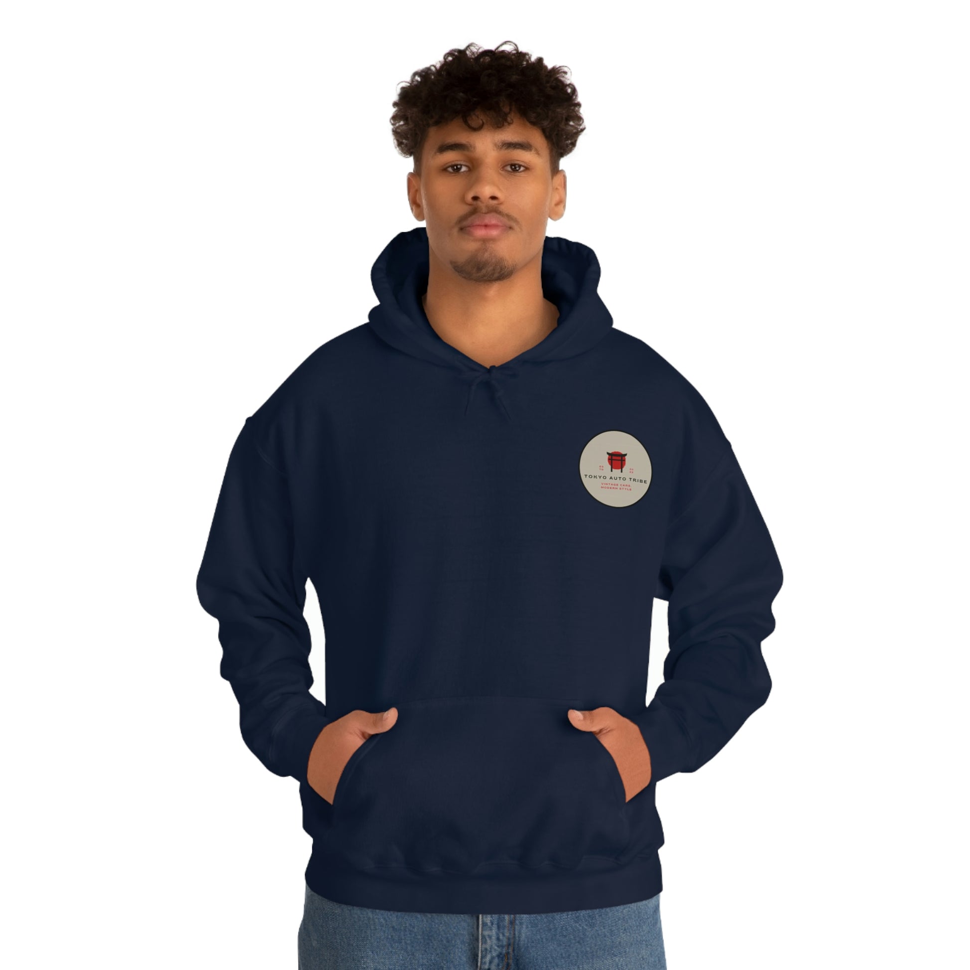 A man wearing a navy blue Groovy Grocery Runner Hoodie with a small circular graphic on the chest, embodying the Tokyo Auto Tribe’s JDM streetwear inspired by late-night drives and Japanese car culture.