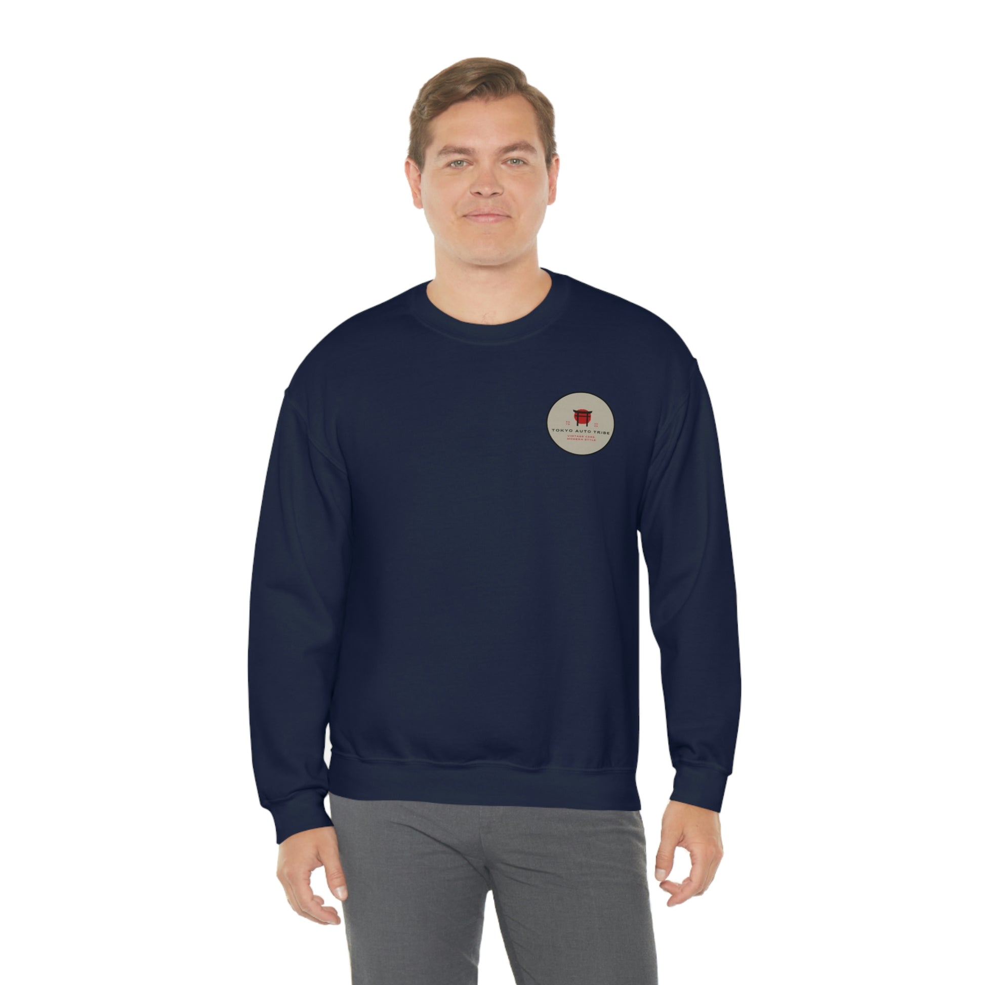 Man wearing a navy blue sweatshirt featuring a small circular graphic on the chest, styled as The Family Wagon Sweater, embodying Japanese car culture and late-night drive vibes.