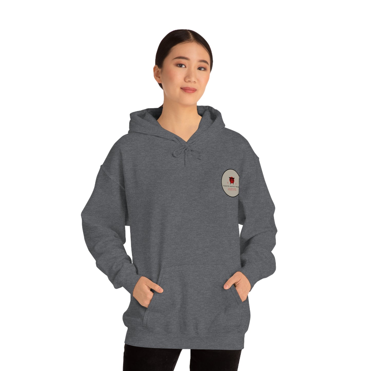 Woman wearing a dark gray Wagon Chibi Hoodie with a subtle Japanese car culture patch on the chest, styled for fans of JDM streetwear and tuner car culture.