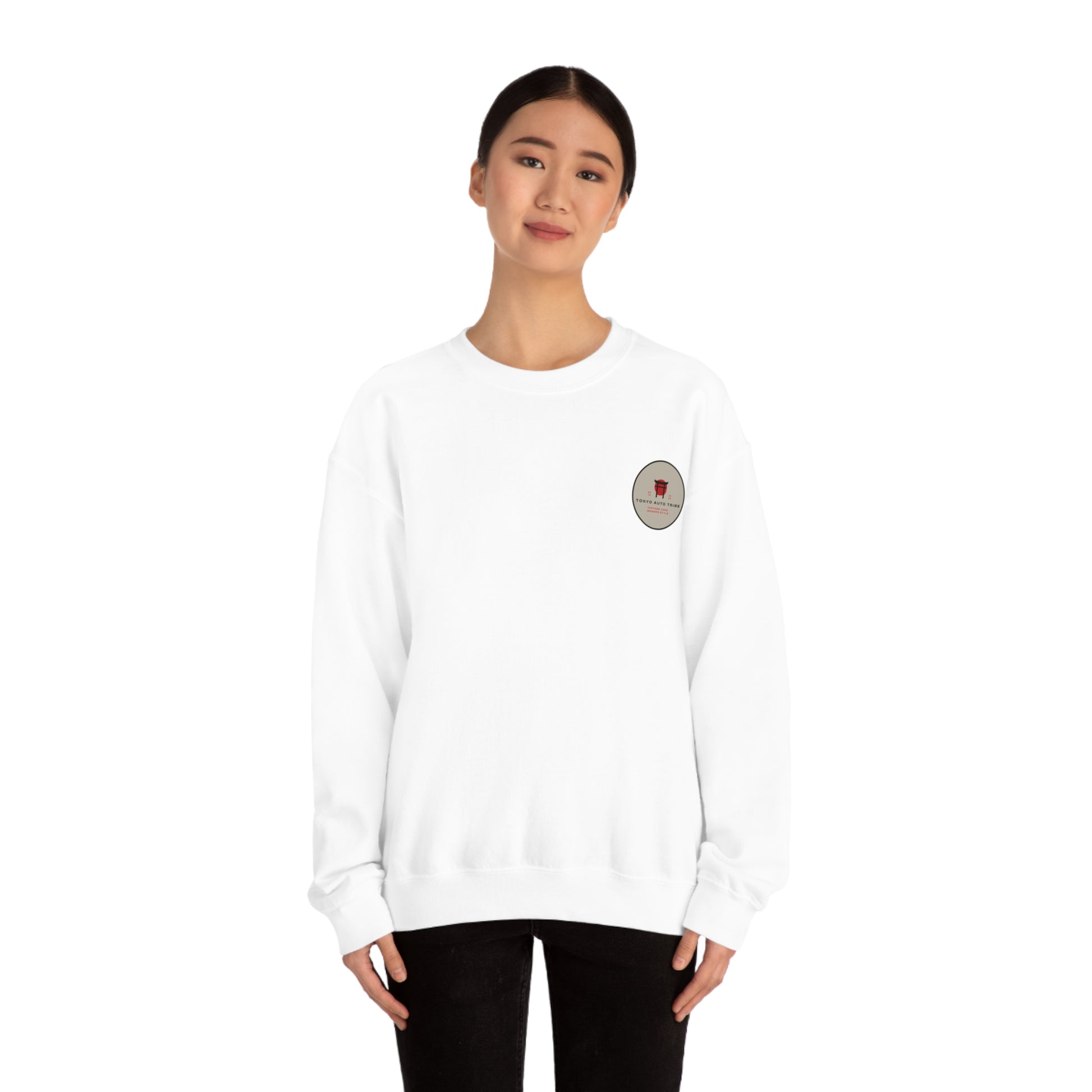 Young woman wearing a white Wagon Chibi Sweater with a small round chest graphic, styled casually for fans of Japanese car culture and streetwear.