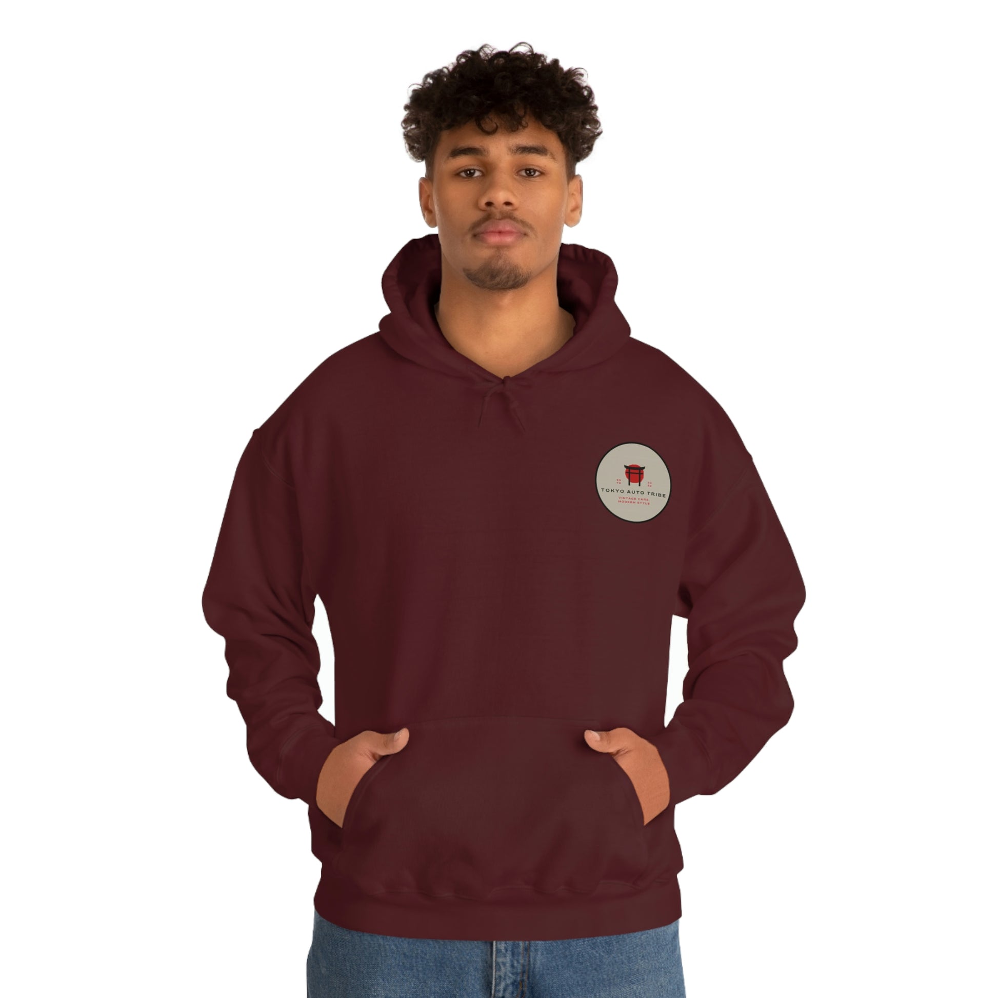 Man wearing a maroon Groovy Grocery Runner Hoodie with a small circular logo on the chest, embodying Japanese car culture and drift-inspired streetwear style.