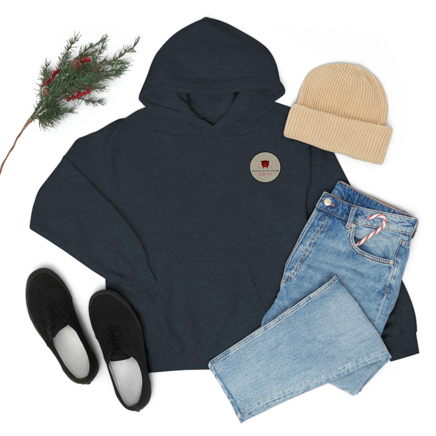 Dark blue Groovy Grocery Runner Hoodie paired with light blue jeans, beige knit beanie, and black casual sneakers, styled with a sprig of greenery and red berries.