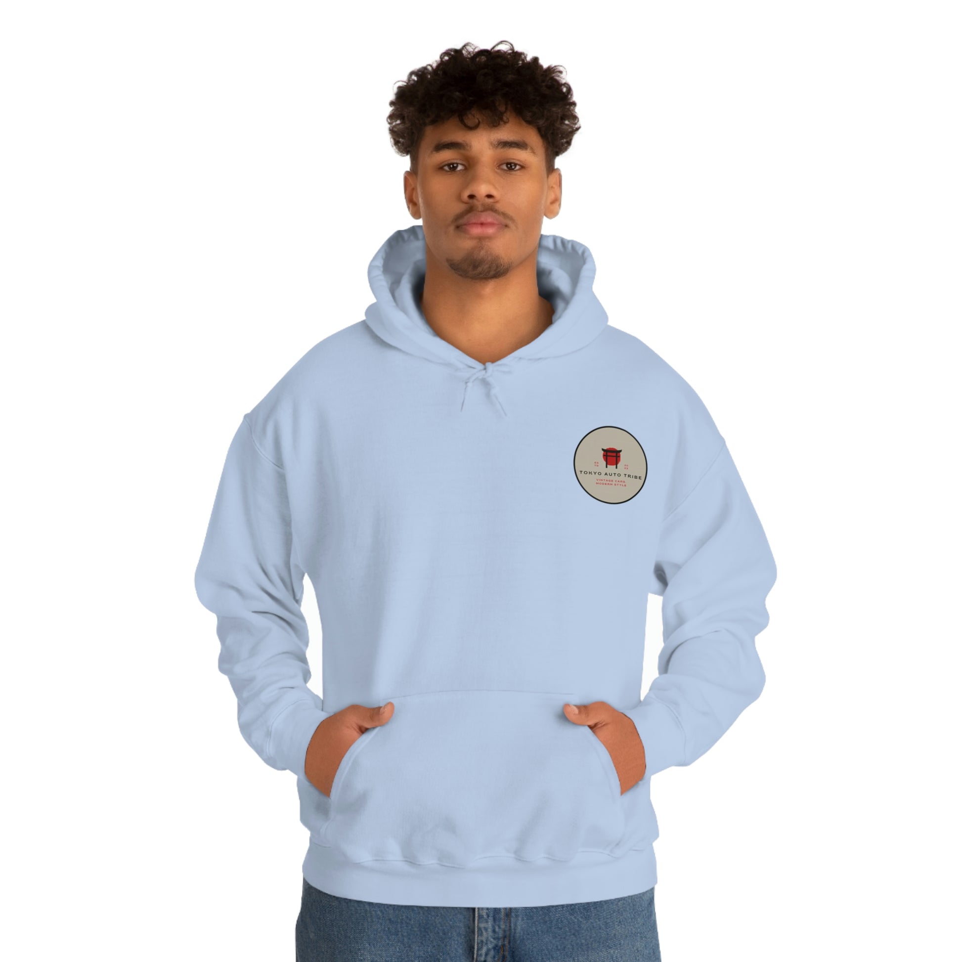 Man wearing a light blue Groovy Grocery Runner Hoodie with a small circular logo on the chest, designed for fans of Japanese car culture and late-night drives.