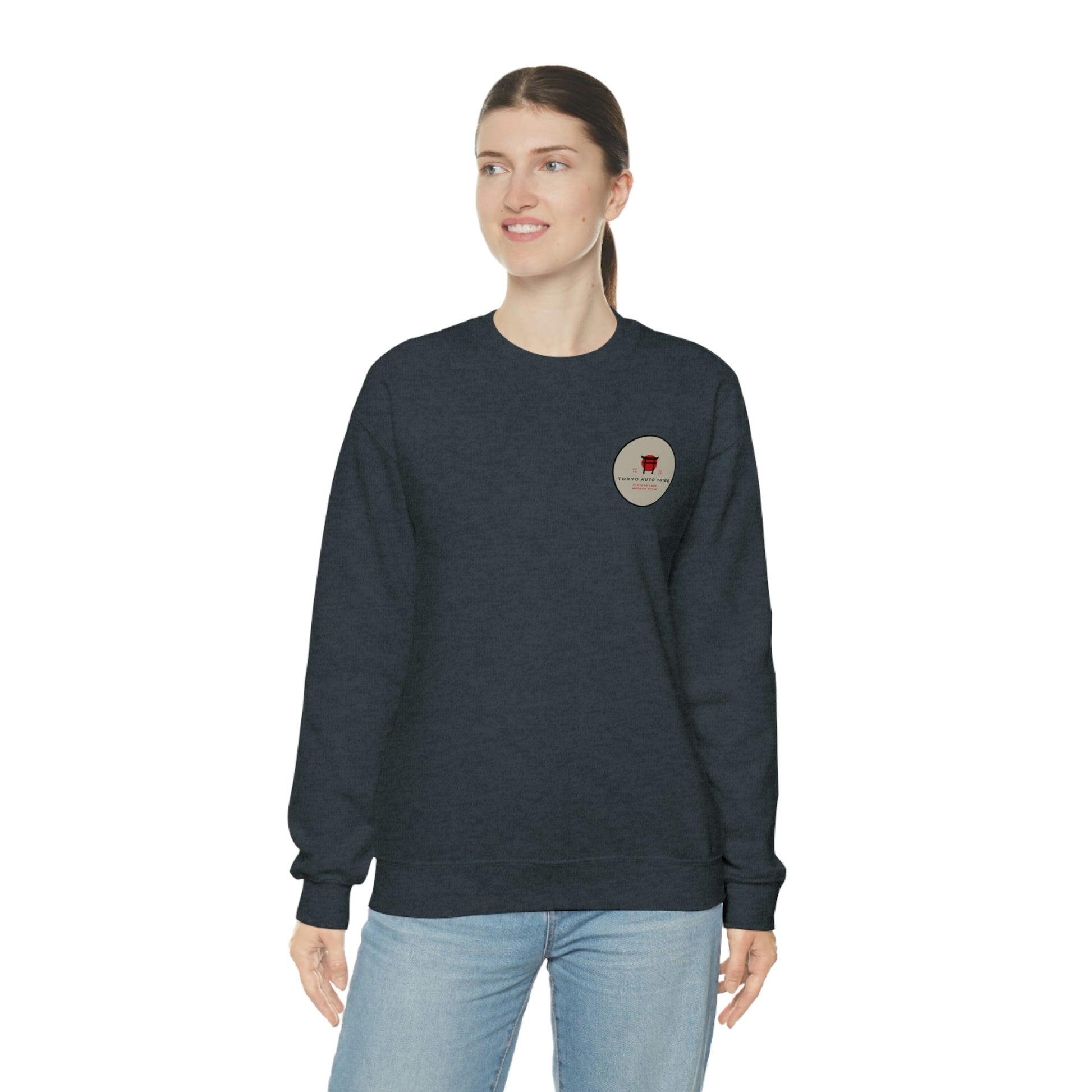 A woman wearing The Family Wagon Sweater in dark fabric featuring a small vintage-inspired graphic on the chest, embodying Japanese car culture and late-night drive vibes.