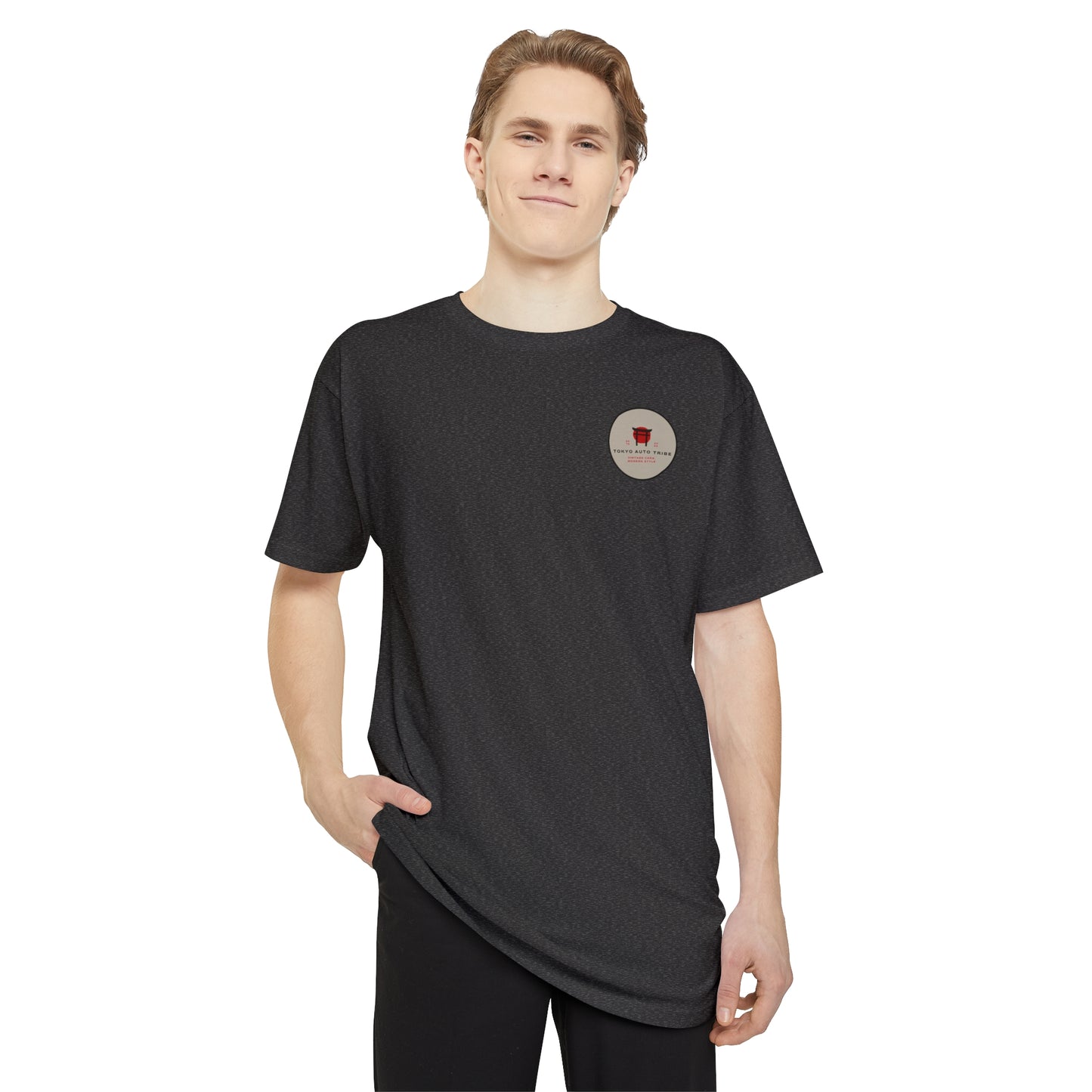 A young man wearing a black Unbreakable Spirit oversized T-Shirt with a small graphic on the chest, embodying JDM streetwear culture inspired by late-night drives and Japanese tuner heritage.