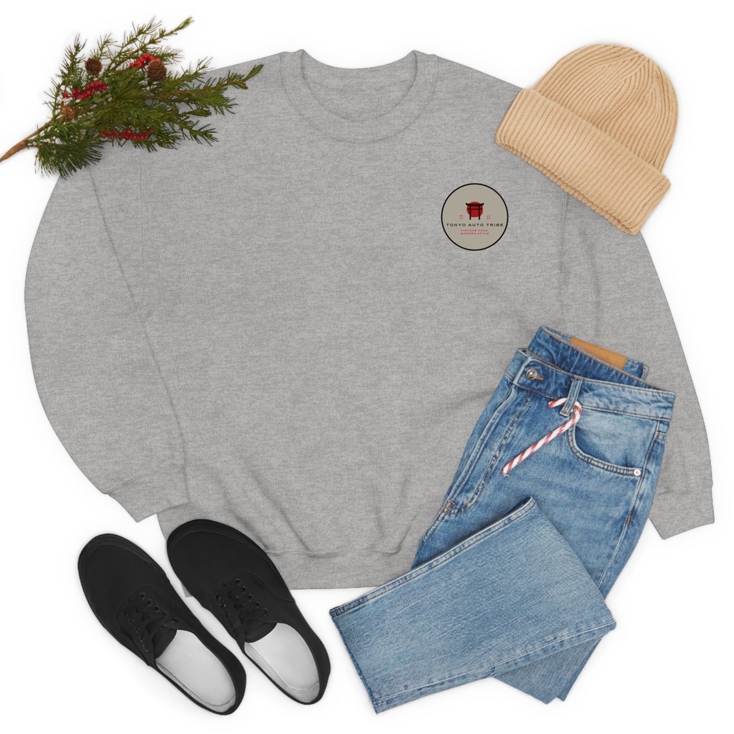 Wagon Chibi Sweater in light gray paired with casual blue jeans, black sneakers, and a beige knit hat styled with festive greenery for a laid-back JDM streetwear look.