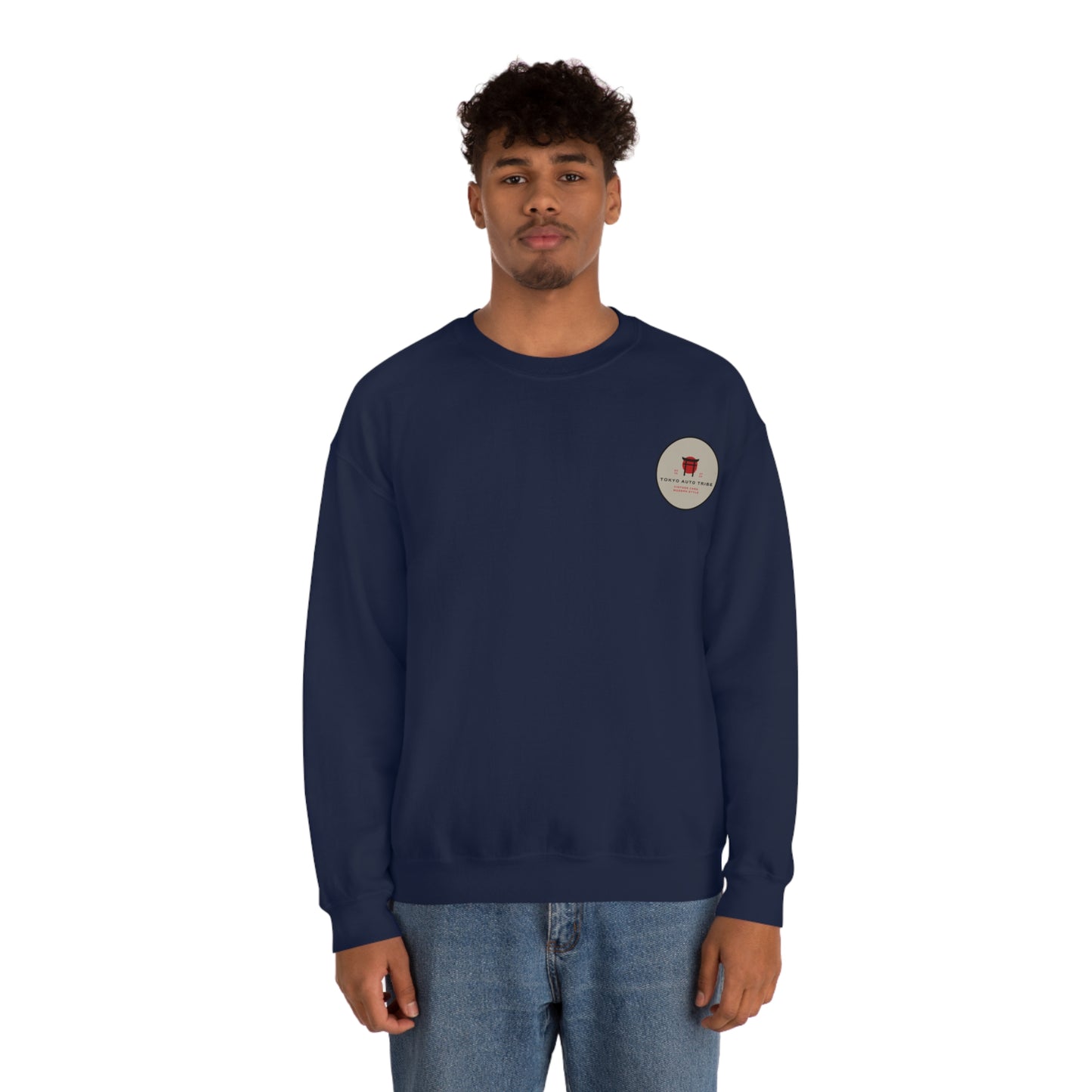 Young man wearing a navy blue Wagon Chibi Sweater with a small circular graphic on the chest, styled in casual jeans, reflecting a laid-back automotive streetwear look built for fans of Japanese car culture and late-night drives.