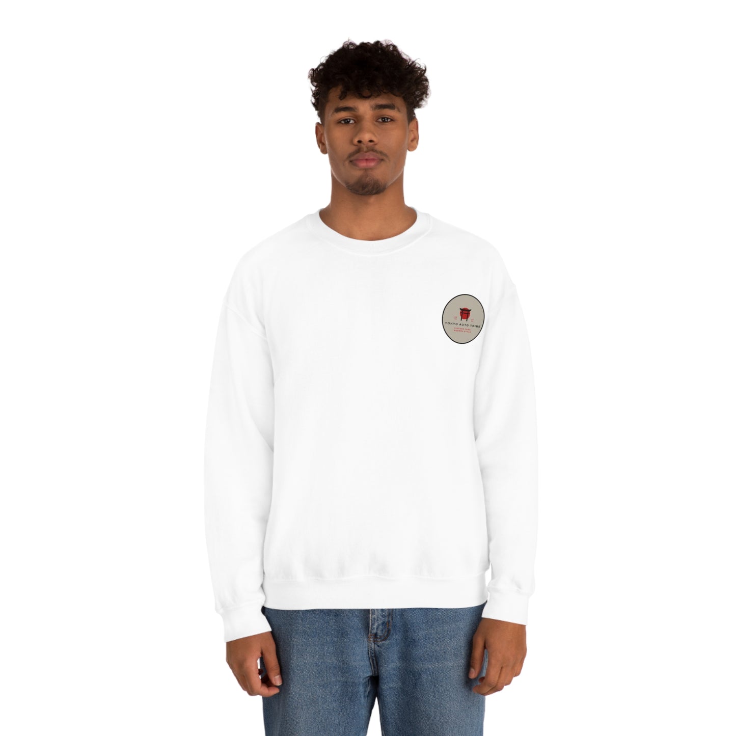 Man wearing a white Wagon Chibi Sweater with a small circular graphic on the chest, styled casually with blue jeans, reflecting Japanese car culture streetwear.