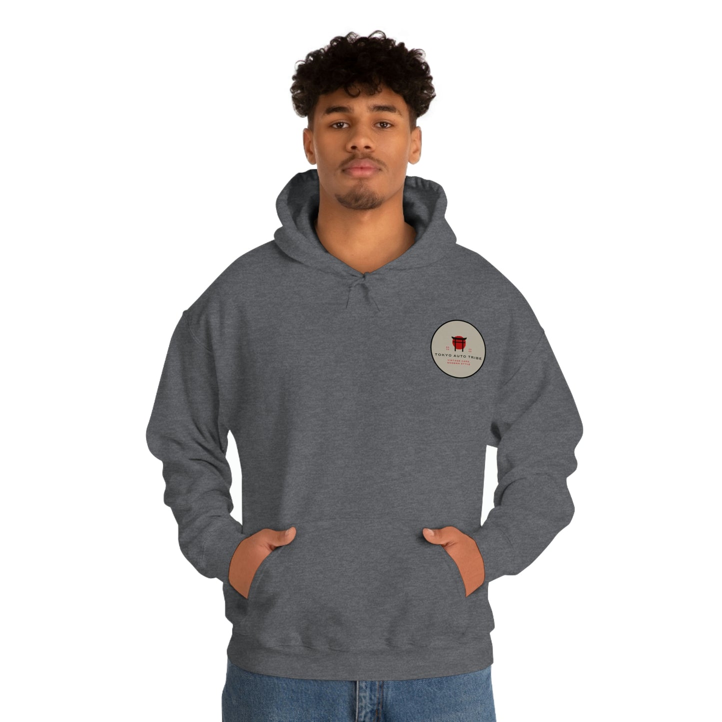 Man wearing a dark gray Groovy Grocery Runner Hoodie with a small circular graphic on the chest, embodying Tokyo Auto Tribe’s late-night Japanese car culture and drift scene vibe.