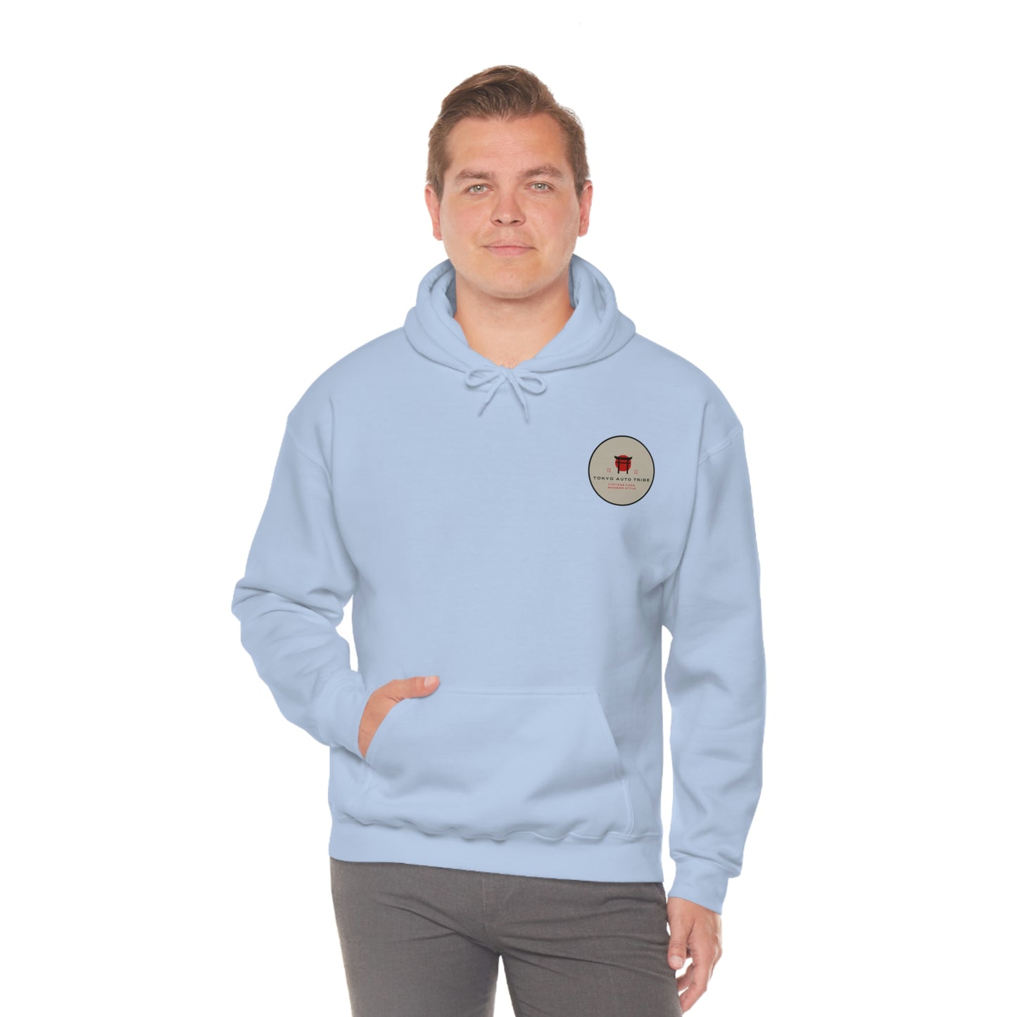 Man wearing a light blue Groovy Grocery Runner Hoodie with a small circular graphic on the chest, embodying the spirit of Japanese car culture and late-night drives.