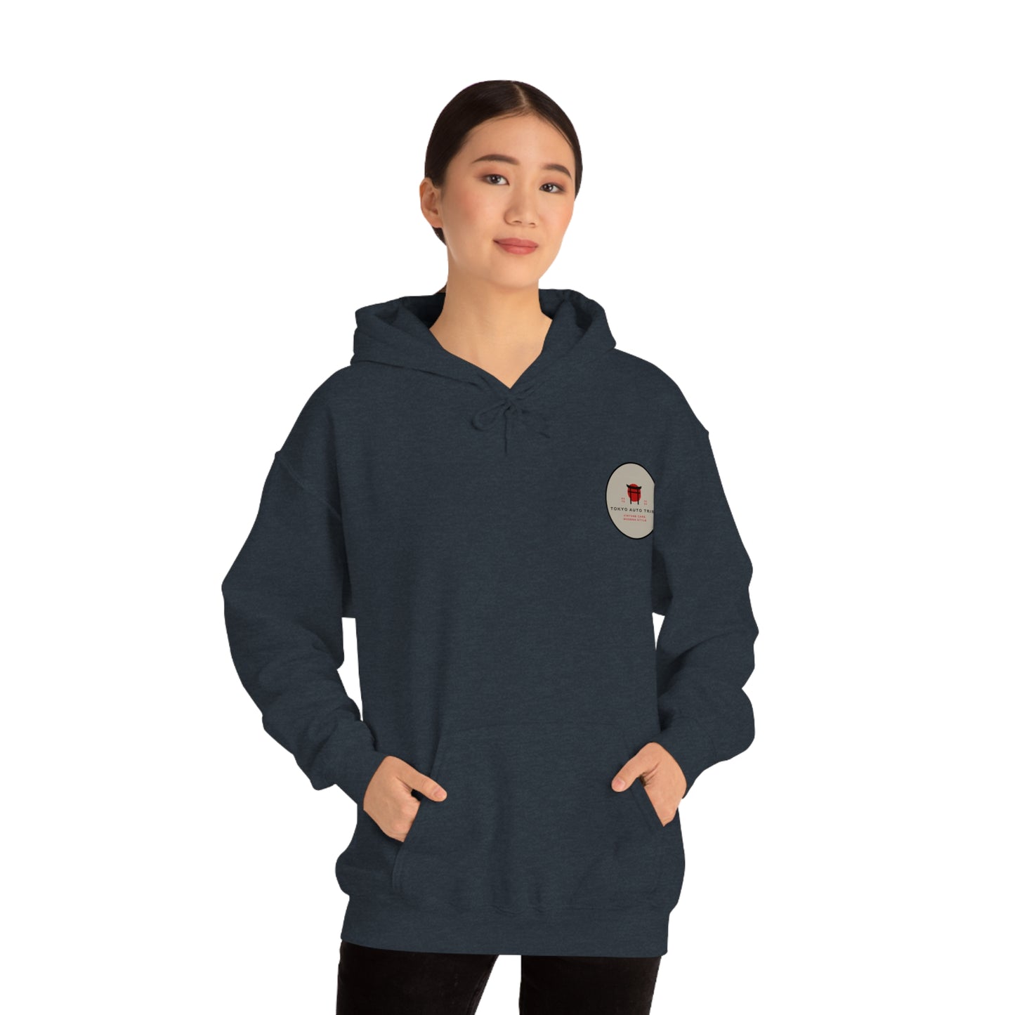 A person wearing a dark hoodie with a small graphic on the chest, showcasing the Wagon Chibi Hoodie designed for fans of Japanese car culture and late-night drives.