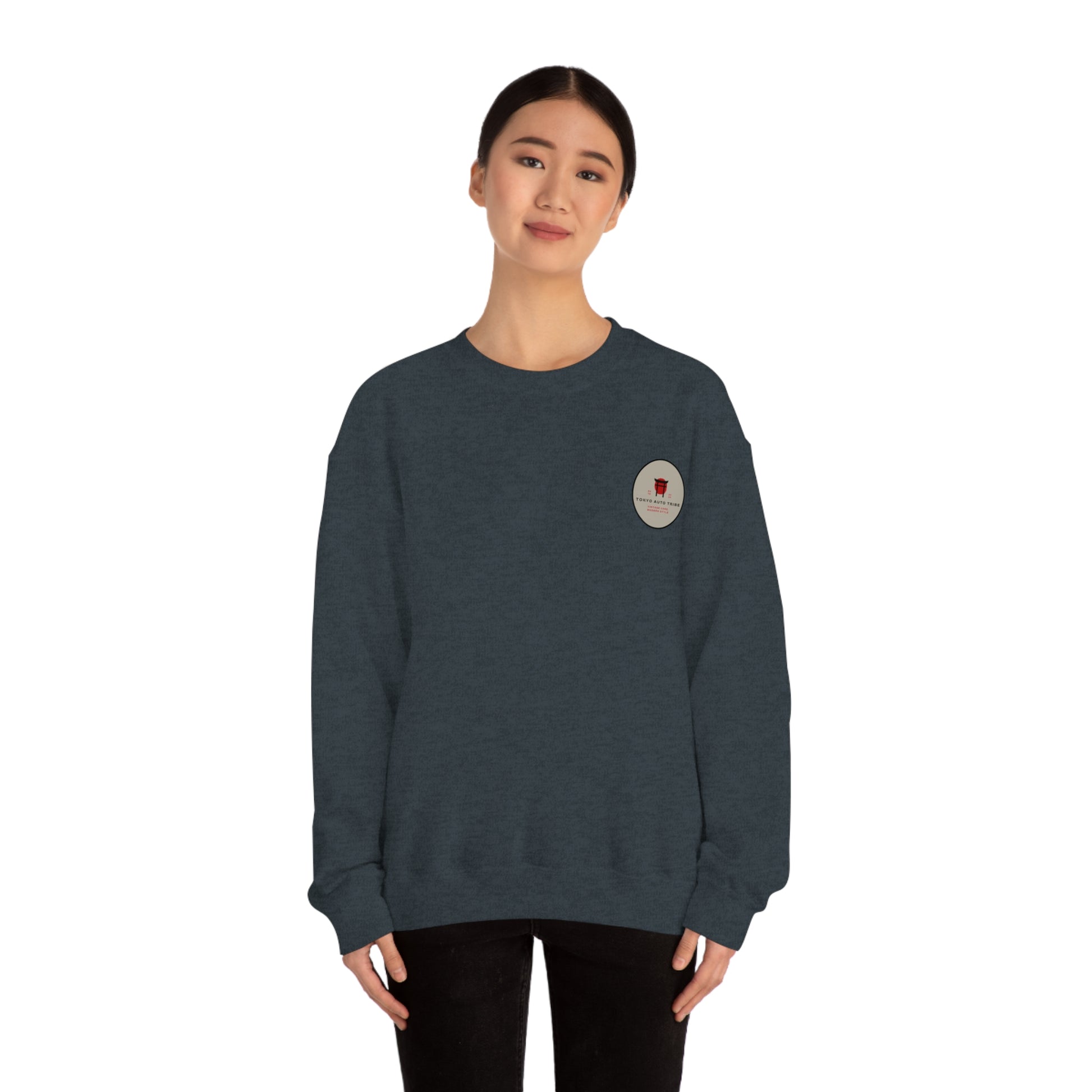 Woman wearing a dark blue Wagon Chibi Sweater with a small graphic emblem, embodying the spirit of Japanese car culture and late-night drives in comfortable streetwear.