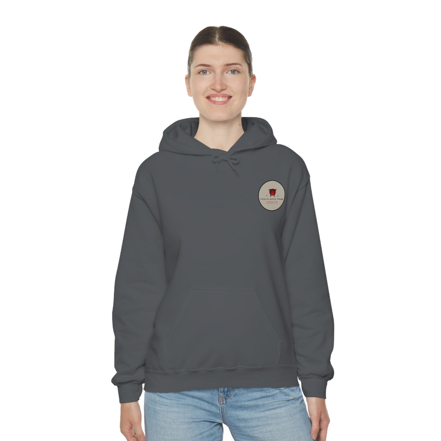 Smiling woman wearing a dark gray Wagon Chibi Hoodie with a small circular graphic on the chest, styled in casual streetwear inspired by Japanese car culture and late-night drives.