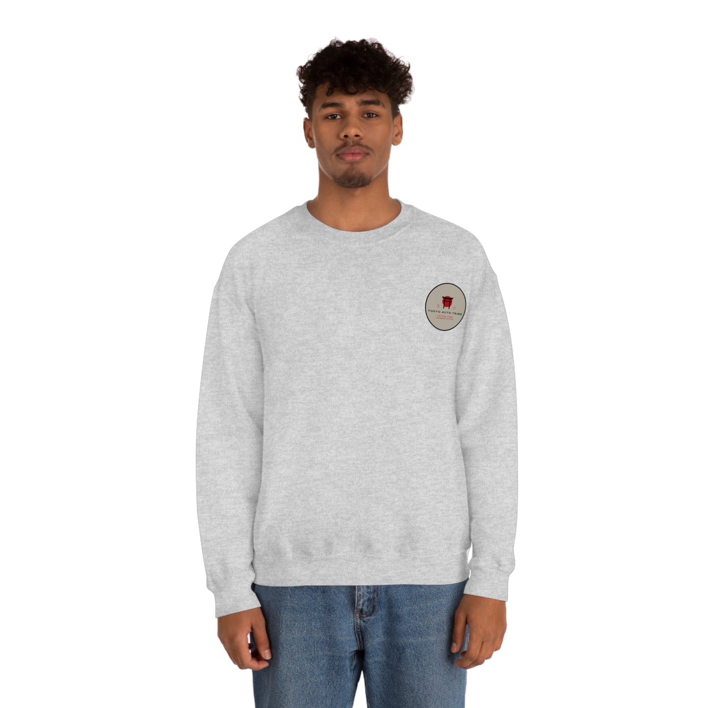 Man wearing a light gray Wagon Chibi Sweater featuring a small circular graphic on the chest, embodying the spirit of Japanese car culture and late-night drives.