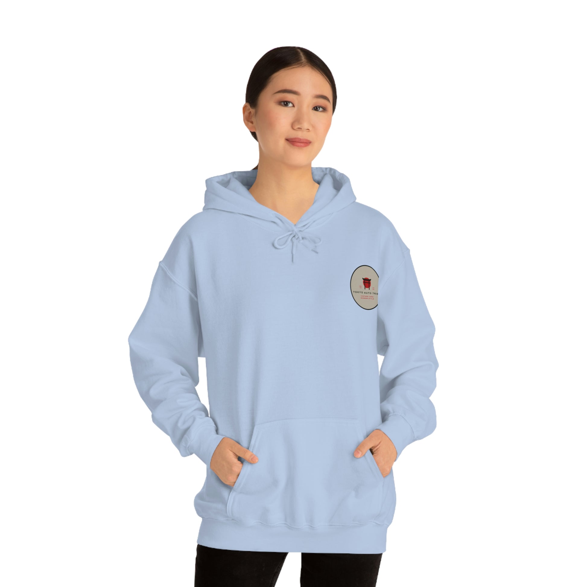 Woman wearing a light blue Groovy Grocery Runner Hoodie with a small vintage-inspired logo on the chest, embodying the spirit of Japanese car culture and late-night drives.