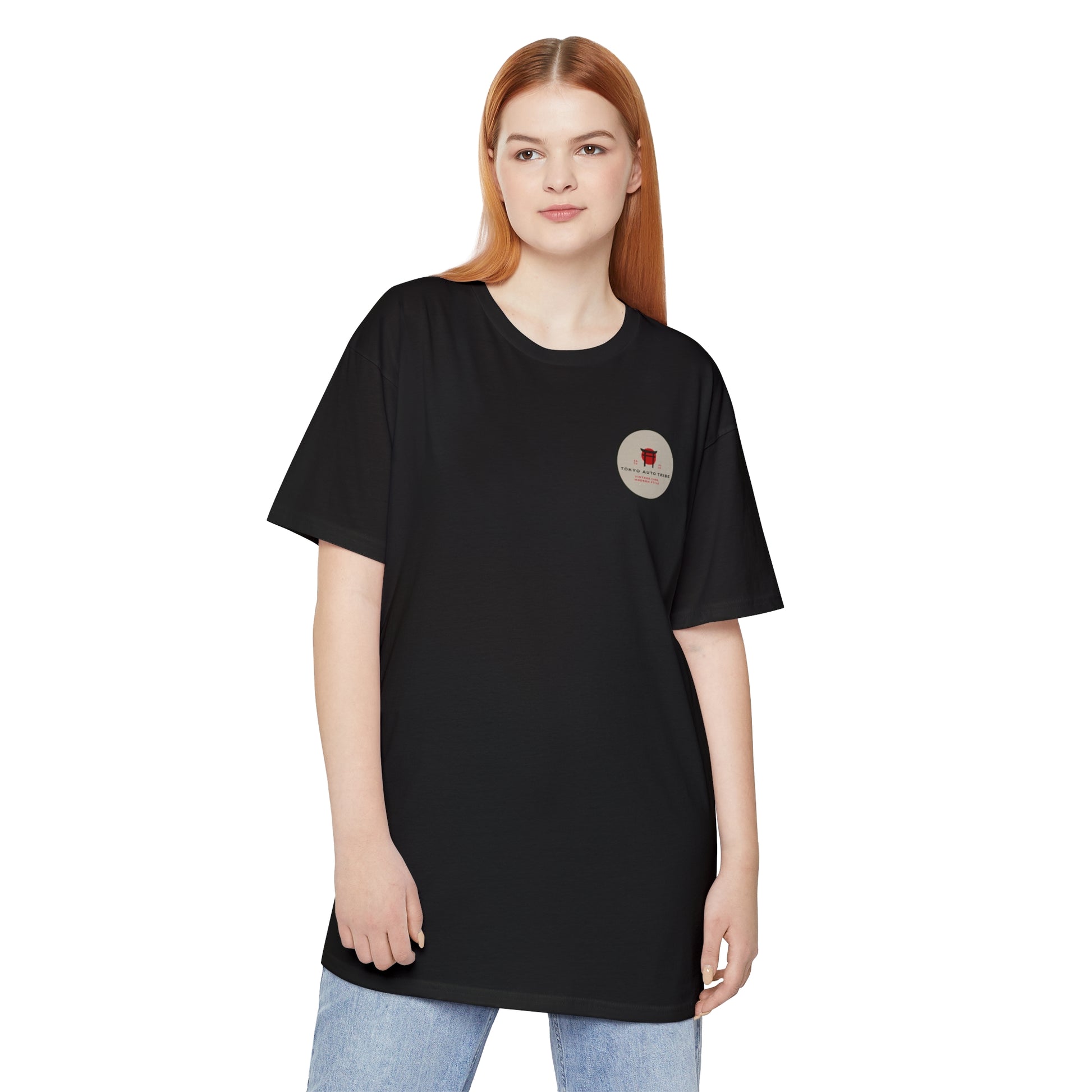 Woman wearing a black Unbreakable Spirit oversized T-Shirt with a small graphic on the chest, styled casually for fans of Japanese car culture and late-night drives.
