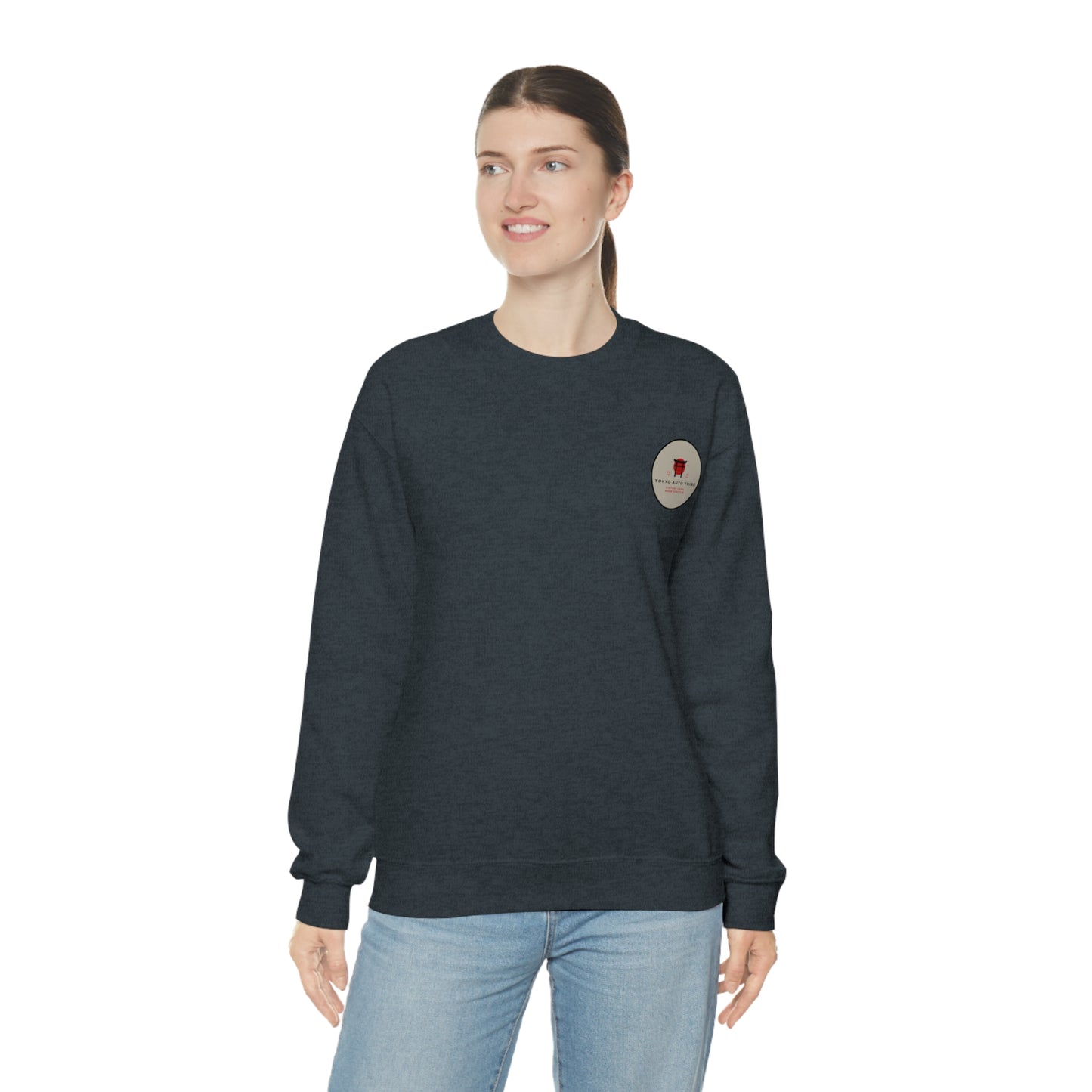 Woman wearing a dark gray Wagon Chibi Sweater with a small graphic on the chest, styled casually with light blue jeans, embodying vintage Japanese car culture atmosphere.