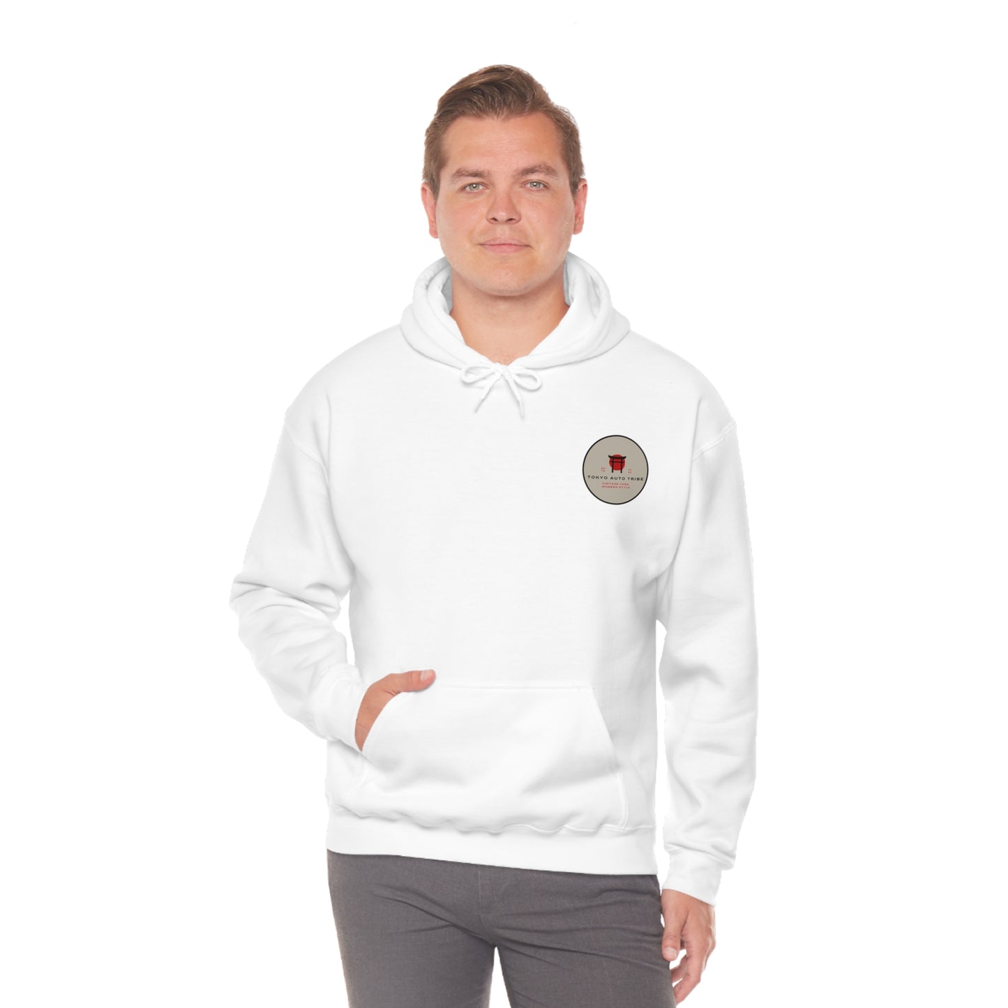 Man wearing a white Wagon Chibi Hoodie featuring a small round patch graphic on the chest, reflecting Japanese car culture and streetwear style inspired by late-night drives and tuner scenes.