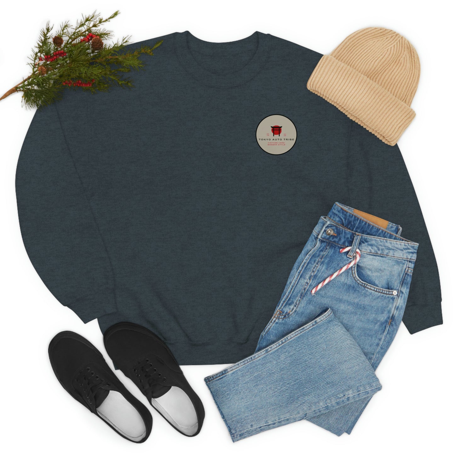 Dark gray crewneck sweatshirt featuring a small round Tokyo Auto Tribe graphic paired with light blue jeans, black sneakers, and a beige knit beanie, The Family Wagon Sweater.