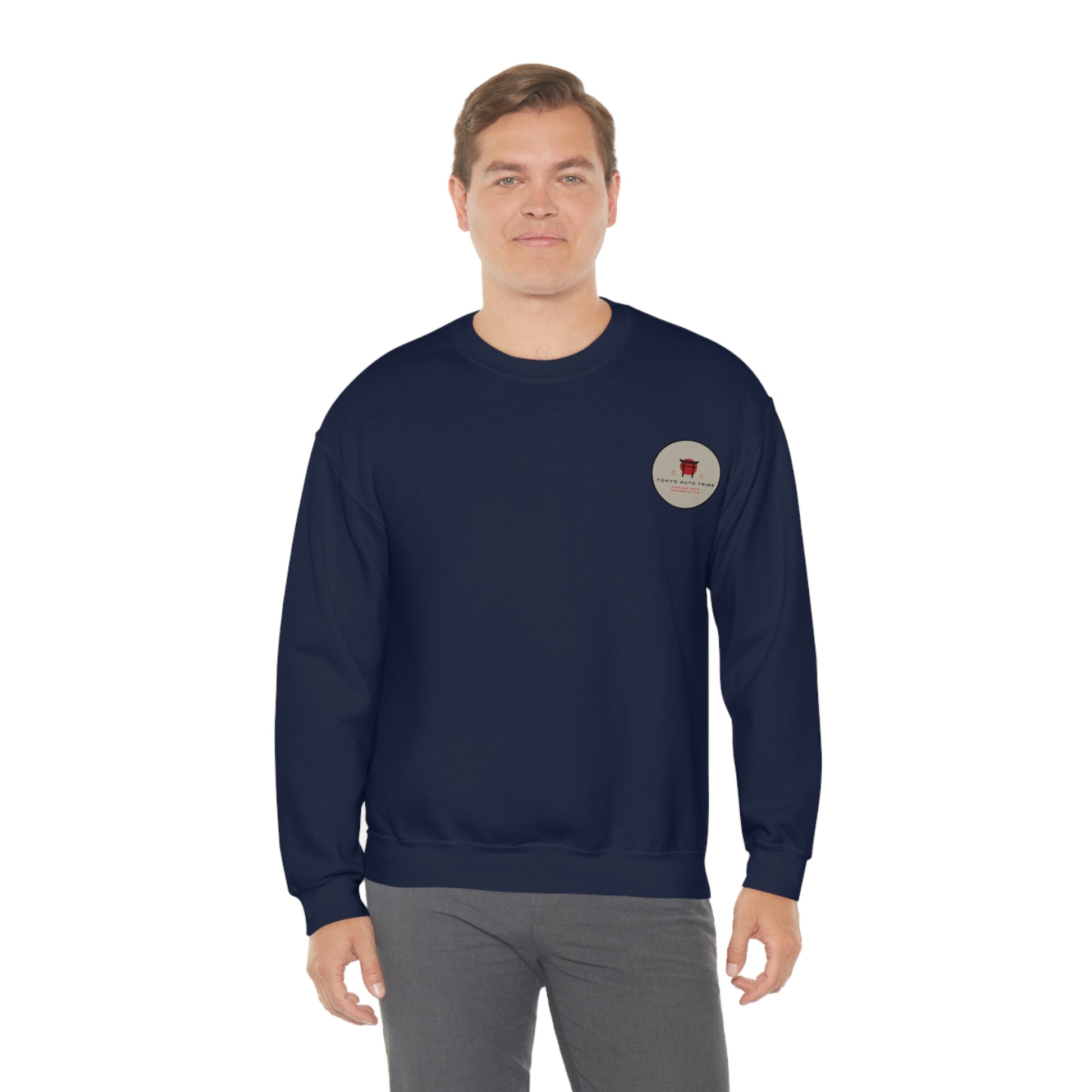 Man wearing a navy blue Wagon Chibi Sweater with a small circular graphic on the chest, styled for fans of Japanese car culture and late-night drives.