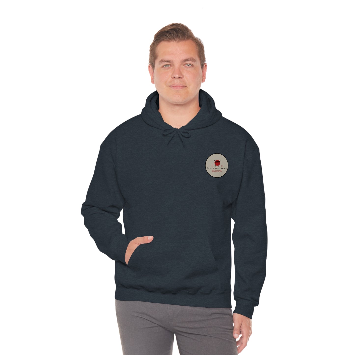 Man wearing a dark hoodie featuring a small graphic emblem on the chest, representing automotive streetwear culture, styled as the Wagon Chibi Hoodie for fans of Japanese car scenes.