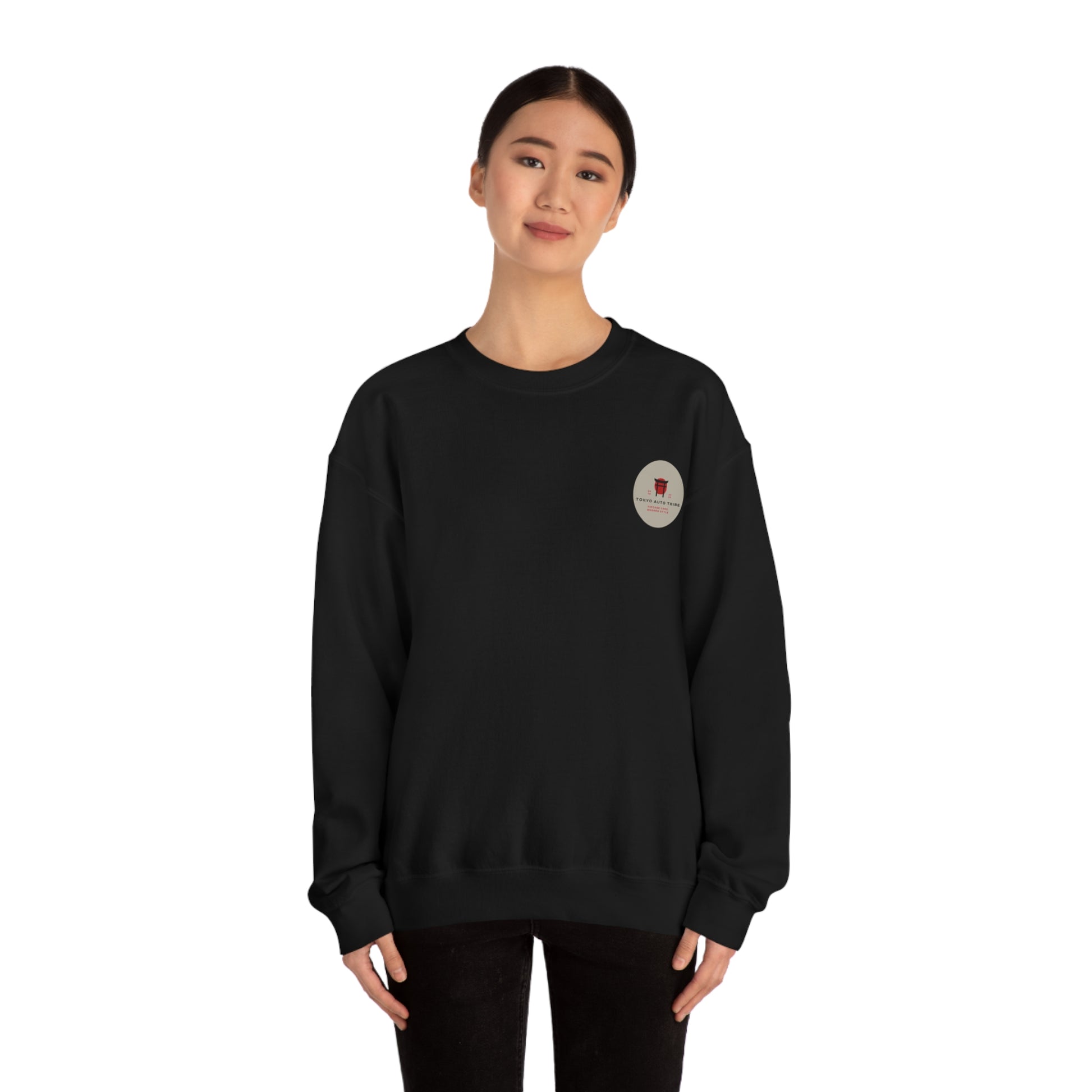 Young woman wearing a black Wagon Chibi Sweater with a small graphic logo on the chest, styled for fans of Japanese car culture, late night drives, and tuner scene fashion.