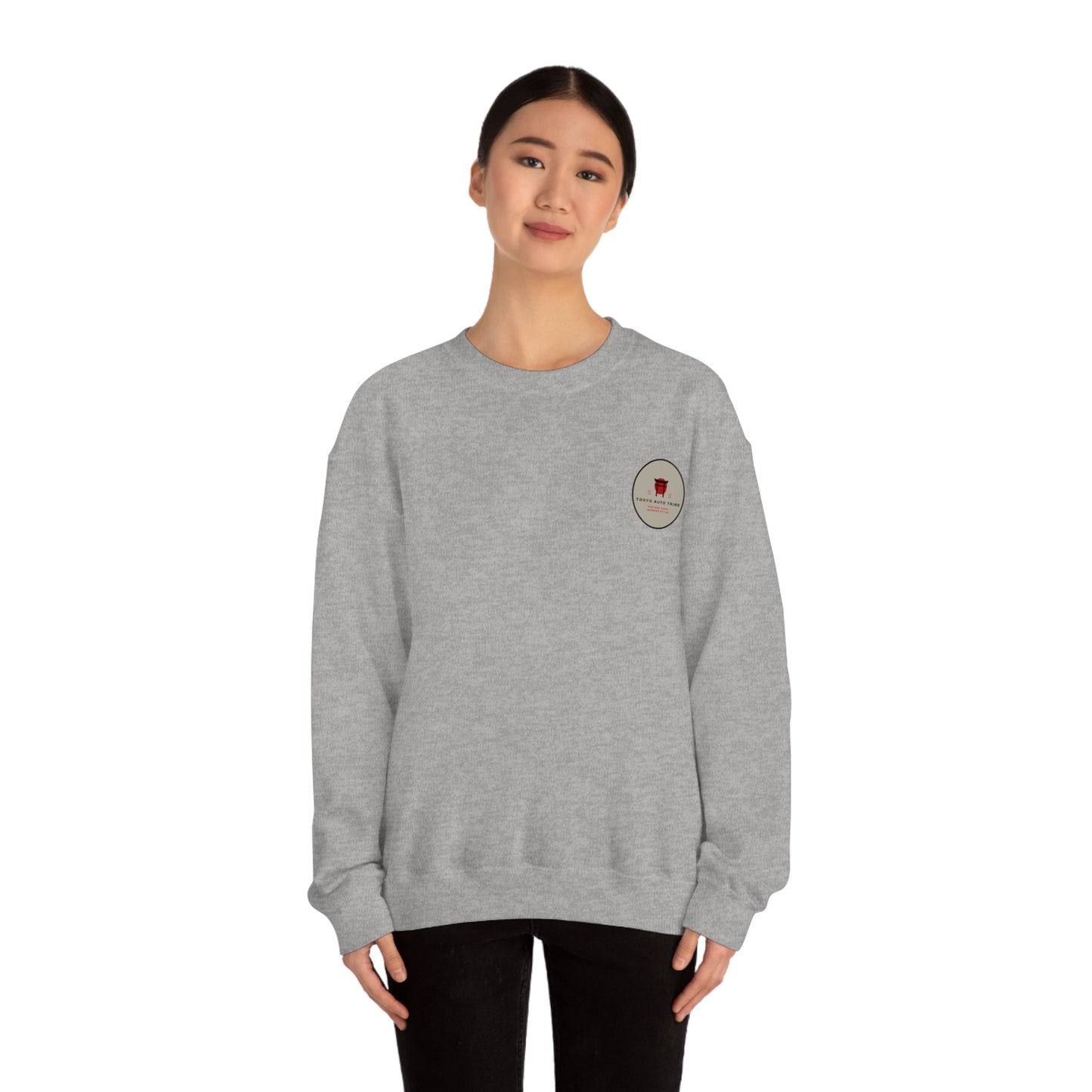 Young woman wearing a grey Wagon Chibi Sweater with a small embroidered design on the chest, styled for casual automotive streetwear inspired by Japanese car culture.