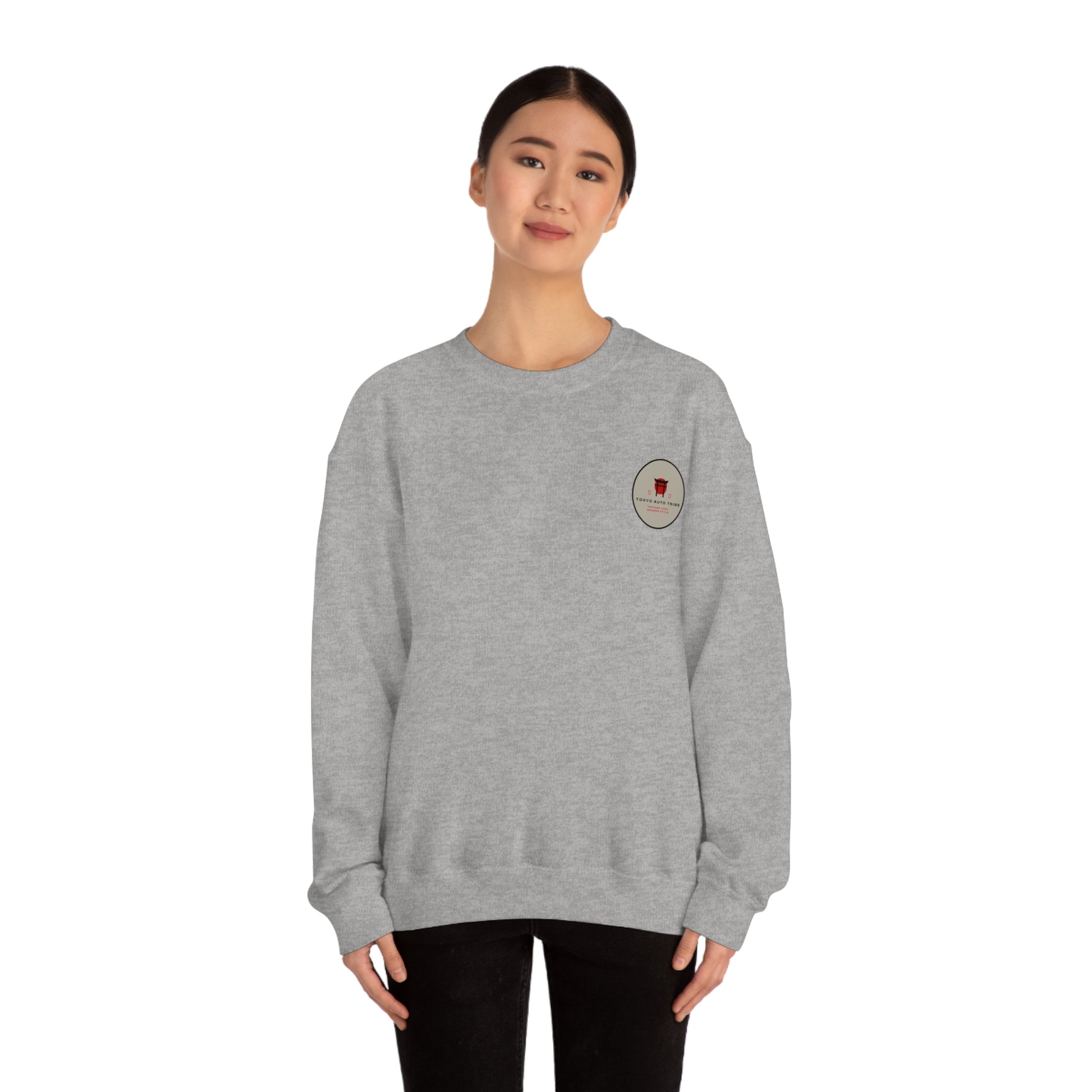 Young woman wearing a grey Wagon Chibi Sweater with a small embroidered design on the chest, styled for casual automotive streetwear inspired by Japanese car culture.