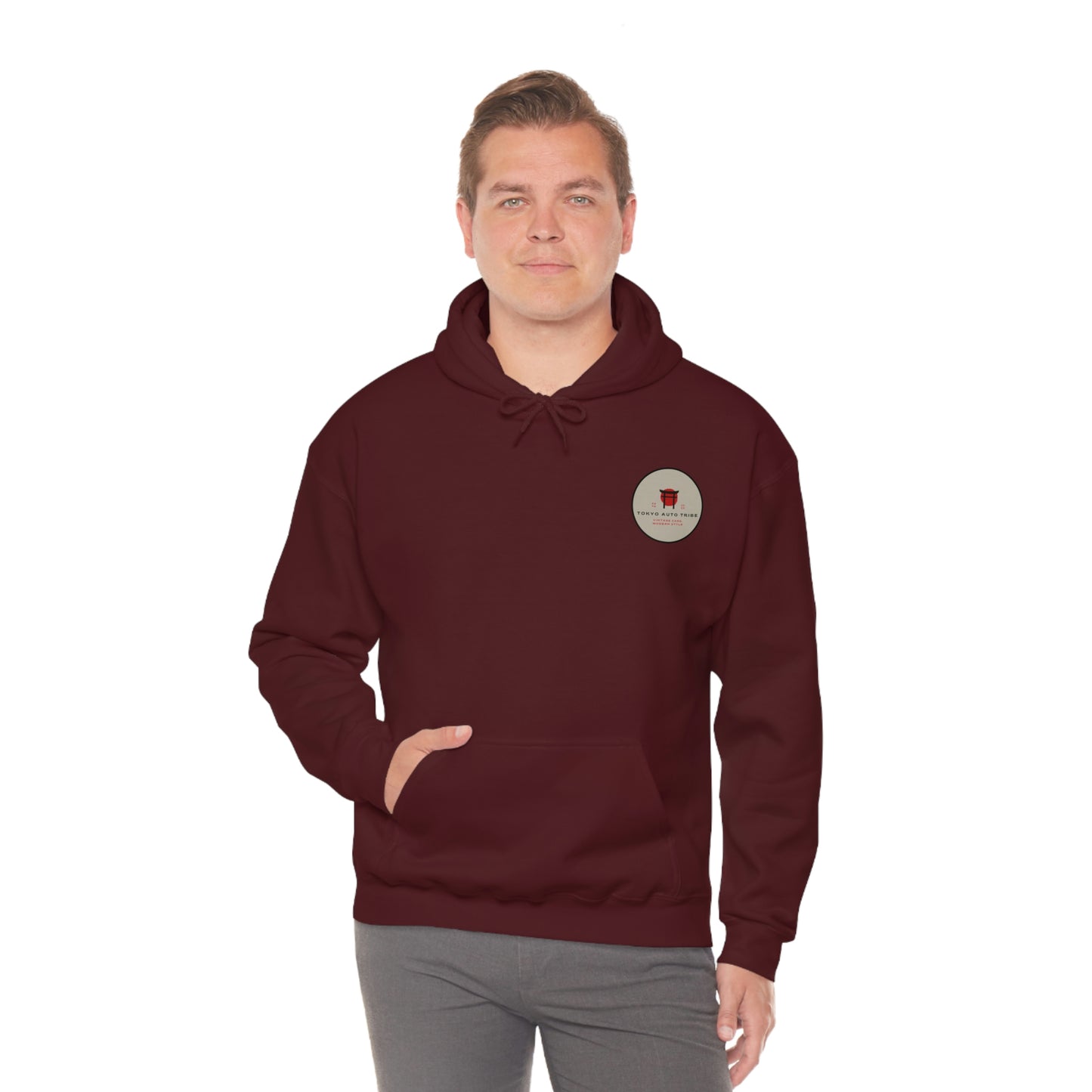 Man wearing a maroon Groovy Grocery Runner Hoodie featuring a small vintage-inspired logo on the chest, designed for fans of Japanese car culture and late-night drives.
