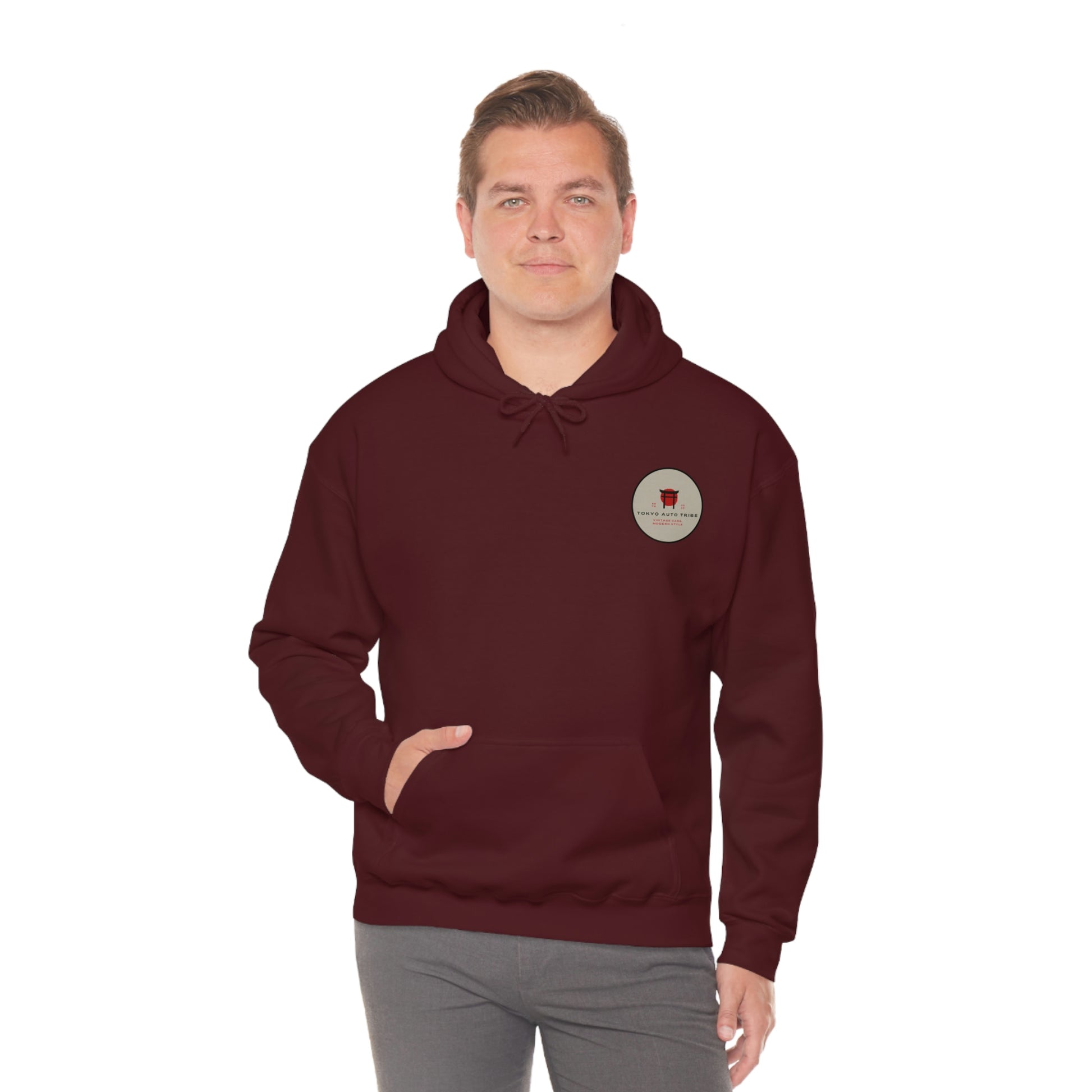 Man wearing a maroon Groovy Grocery Runner Hoodie featuring a small vintage-inspired logo on the chest, designed for fans of Japanese car culture and late-night drives.