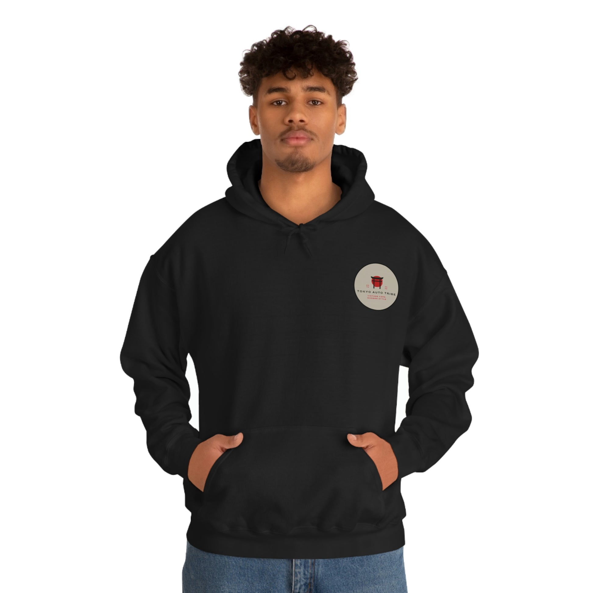 Man wearing a black Groovy Grocery Runner Hoodie with front pocket and subtle graphic emblem, embodying Tokyo Auto Tribe's Japanese car culture and late-night drive vibe.