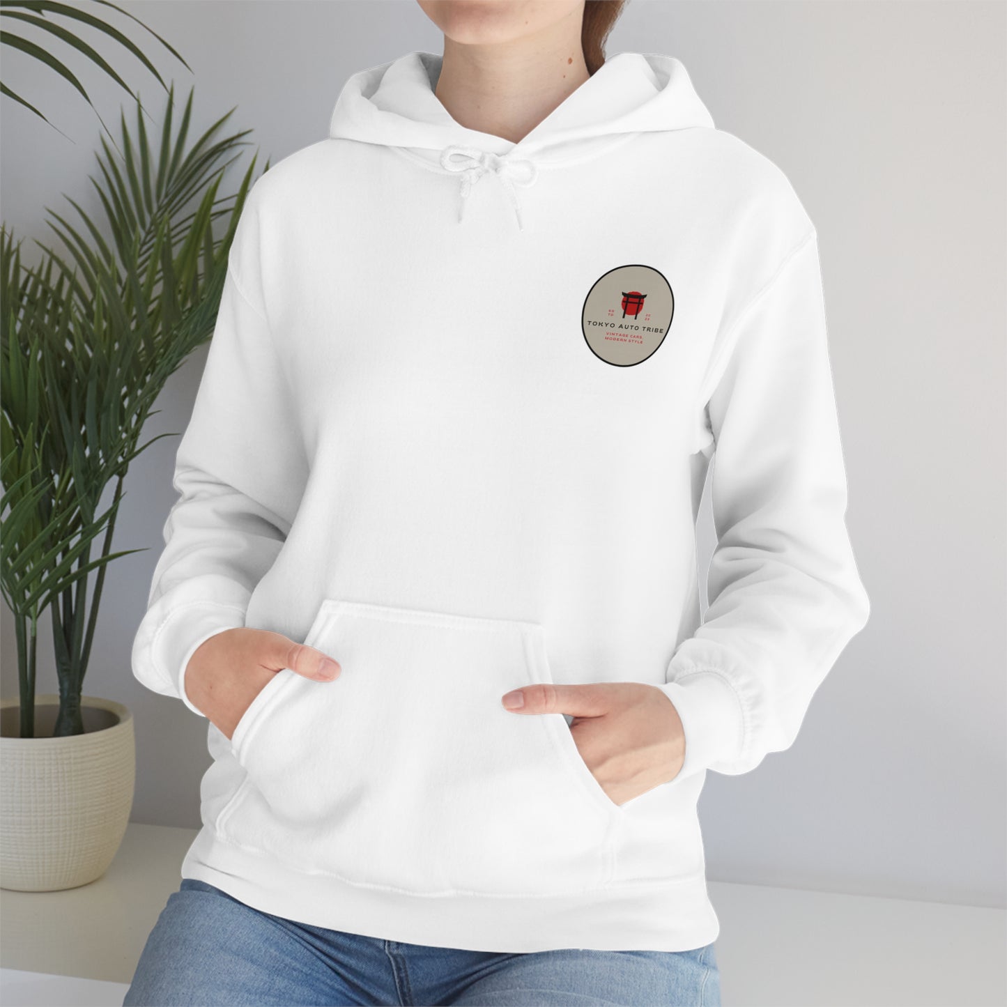Person wearing a white Wagon Chibi Hoodie featuring a small graphic logo on the chest, styled for fans of Japanese car culture, late-night drives, and drift scenes.