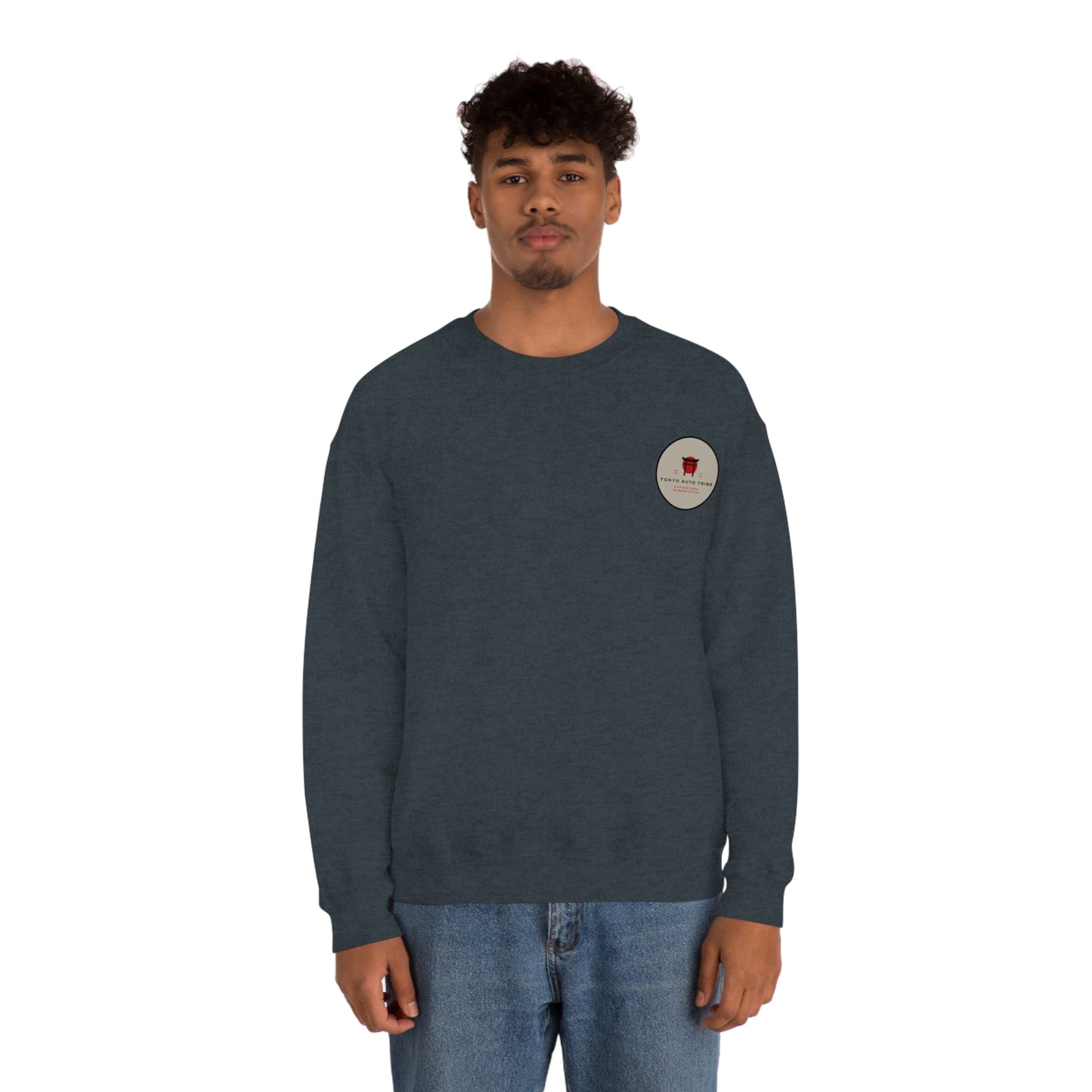 Man wearing a dark gray Wagon Chibi Sweater with a small round graphic on the chest, styled with casual blue jeans, embodying Japanese car culture and late-night drive vibes.