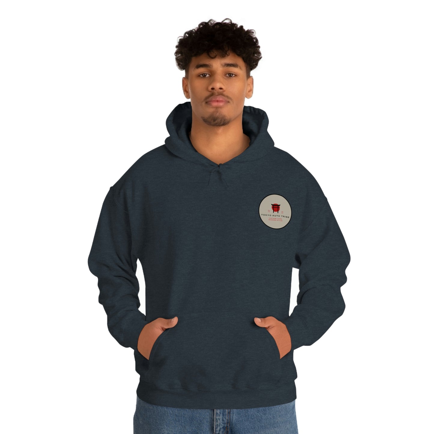 Man wearing a dark blue Godzilla's Fury Hoodie with a small circular logo on the chest, standing with hands in pockets and a neutral expression against a white background.