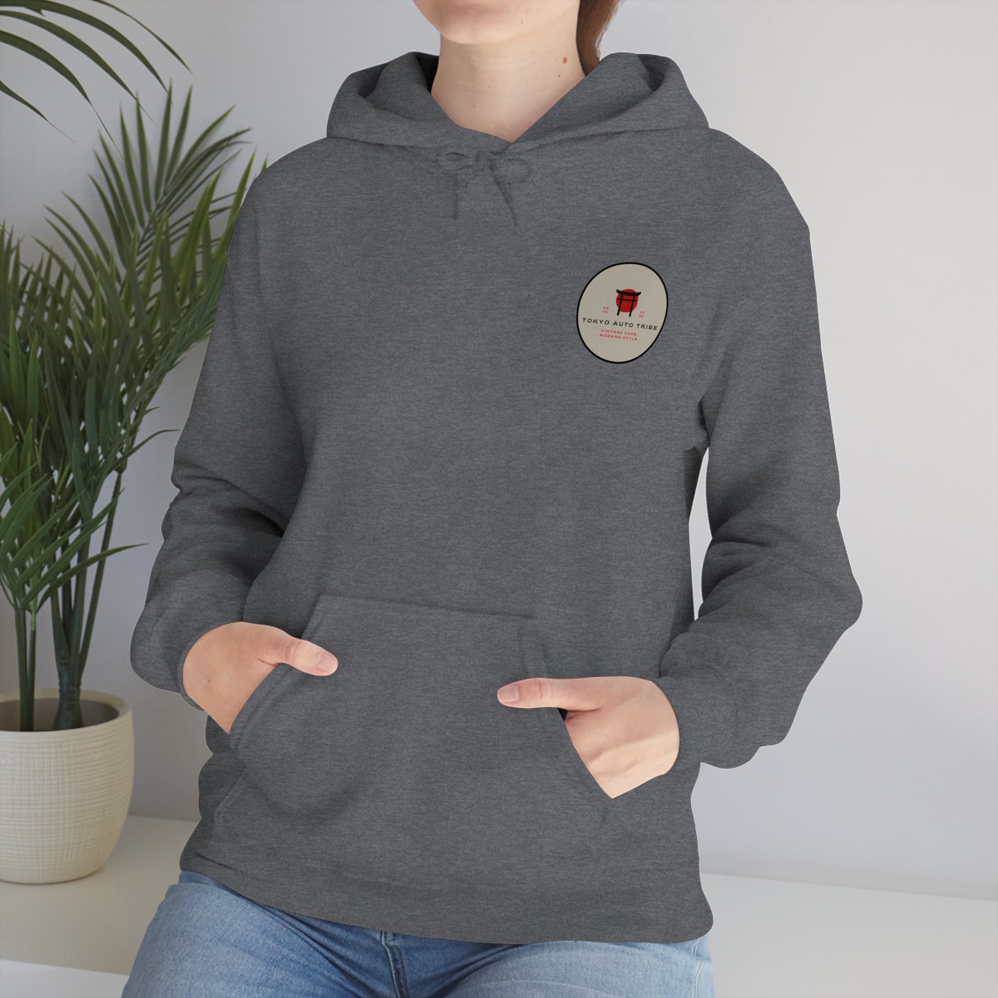 Person wearing a gray Wagon Chibi Hoodie with a small circular logo on the chest, styled for fans of late-night drives and Japanese car culture.