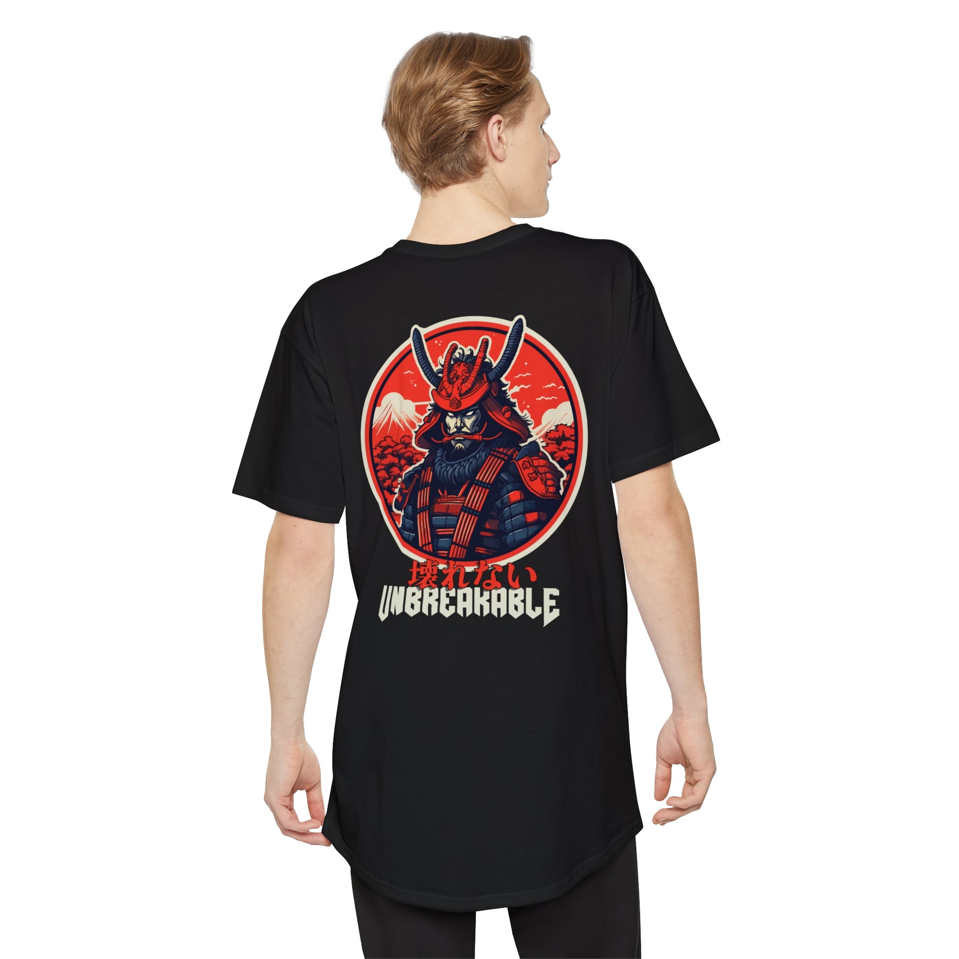 Man wearing a black Unbreakable Spirit oversized T-Shirt featuring a bold red and orange graphic of a samurai helmeted warrior with mountains in the background, capturing the spirit of vintage Japanese car culture and late-night drives.