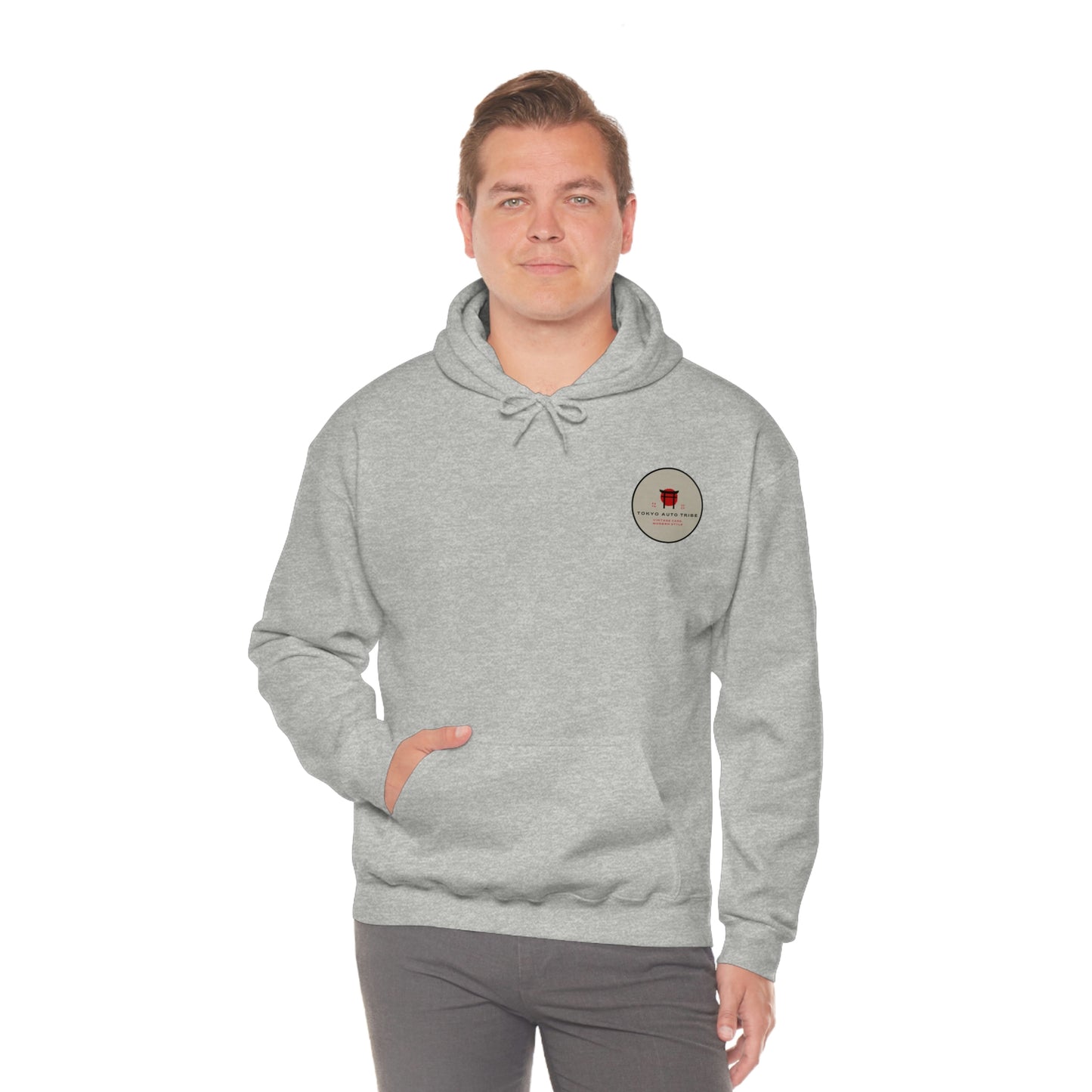 Man wearing a light gray Groovy Grocery Runner Hoodie with a small circular red and black graphic on the chest, combining comfort and JDM streetwear style for Japanese car culture fans.
